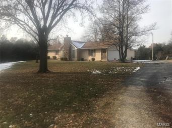 NEW YEAR --- NEW PRICE Country Living with-in minutes of town. Four bedroom ranch with full walk out basement sitting on 12.9 minimal restricted acres. 
Lots of space in the vaulted family room offering a wood burning stone fireplace, four spacious bedroom on the main level. Updated eat in kitchen, main floor laundry room with 1/2 bath. Lower level has custom bar and kitchenette area. Walks out to over-sized patio overlooking the tree lined property. Did I mention the two car detached garage with three overhead doors for all the toys and equipment. 
Restrictions are mainly no mobile homes and no swine.
Get ready to call this one home!