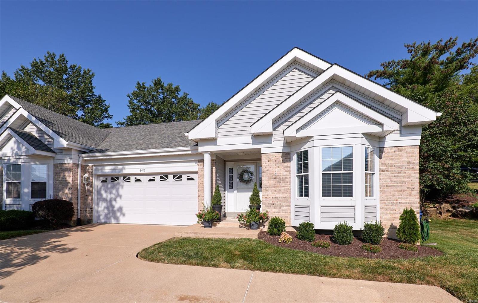 Welcome home to this beautiful villa in the Lake St. Louis CA. Enjoy this Lifestyle Community offering lakes, boating, fishing, clubhouse, pool, tennis, golf & more. As you wind around the cul-de-sac you'll love the extra parking, pretty landscaping, 2 car & covered porch. WOW! So many Upgrades...wide plank wood floors, vault, stylish lighting, dining space & gas FP. Kitchen boasts stainless, tile, new counters,white cabs, Butlers Pantry & the Breakfast Nook opens to a Sun Room where you'll feel you are on vacation surrounded by trees & a gorgeous landscape accentuated with natural boulders. The spacious master offers a full bath, DBL sinks, tile & large walk-in. The guest bath is fully remodeled with stylish tile, vanity & glass shower doors. Did we mention main floor laundry? The iron spindled stairway leads to a bonus space which opens to a massive Family RM with built-ins, & new flooring. A remodeled bath, sleeping rm plus walk-in closet round out the perfect Lower Level. Location: End Unit