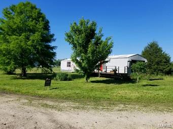 2 bedroom 2 bath 16x80 modular home with utility room setting on 1.60 acres. Wood deck on back. Beautiful property just needs a little TLC.