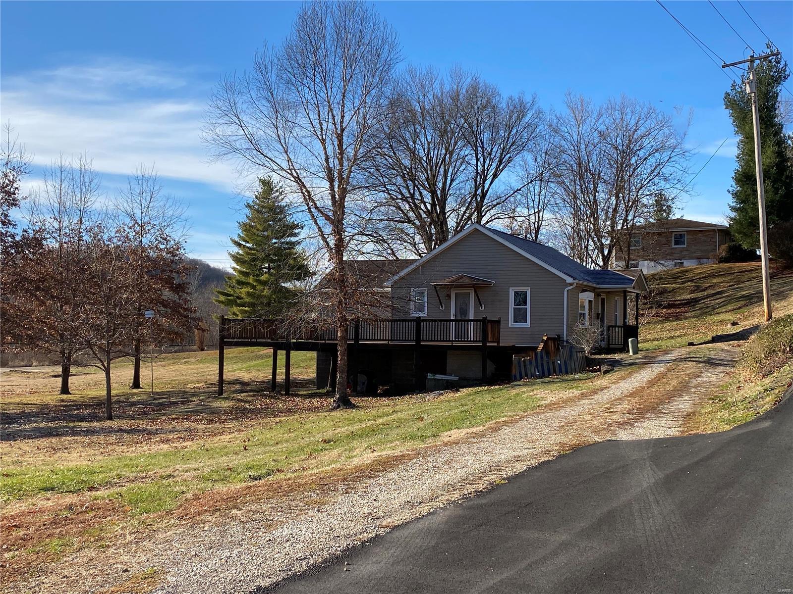 This adorable bungalow/cottage sits on a 1.451 acre lot in a low traffic neighborhood. It has lovely woodwork & attention to detail inside. Priced lower Seller deciding to sell "As is," and because it is not for the faint of heart... it is located in a flood plain and during heavy flooding water does get into the walk-out basement. Current owner has lived here since 1996 ... she's not one who has been faint of heart. :-) 
Like she has had to, you may have to make some temporary modifications until flood waters go down. But if you want it as a weekend getaway, you wouldn't even have to worry about it when flood waters are high. Or maybe you can come up with plans to divert water...? Selling "as is, where is" with some repairs needed as well.
Preapproval or proof of funds required to schedule showing. Call today for more info and/or for help getting connected to a lender.
