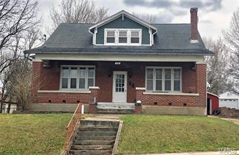 All brick, 2story, 6 bedroom home with heaps of character on a large, flat lot in town! This spacious home has room for everyone! The fantastic front porch beckons you to sit & relax. Original tongue/groove hardwood floors in most rooms. Tall ceilings & oversized windows throughout the main level allow plenty of light to come in & create an open feel. The formal dining room & large kitchen with eat-in space allow for casual or formal living. Three large bedrooms on the main level (one is currently used as a music/office room.) The upstairs has it's own exterior entrance, 3 more bedrooms, loft area & a recently updated bathroom & storage room. Full walkup basement w/storage spaces & workspace areas. The back yard is oversized, flat & mostly fenced making it a great play space for your family and pets. The detached 2 car garage also has workshop and storage areas. This is a large, solid home yet has room for sweat equity & improvements to your own taste. Make this great house your home!