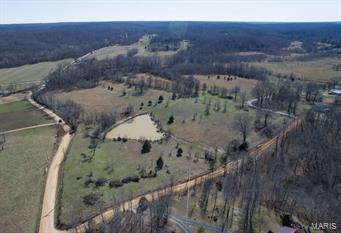 315 acres +/- FOR SALE, 8 miles North of Poplar Bluff, Butler County, Missouri  Located on County Road 523 (Tower Road) and Ritzy Lane, this multi-use property offers a variety of opportunities. New woven wire perimeter fencing on metal post surrounds roughly 150 acres of pasture with cross-fencing and new metal gates. Working pens and runs as well as 60x35 hay barn.  Over 1/4 mile of County Road frontage to the East. County road frontage to the West.  Stocked pond, fresh water flows through property.