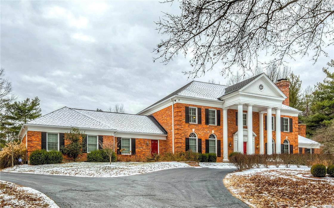 PRICE REDUCED to sell now!  Make this stately custom home situated in prestigeous Wheatfield Estates YOURS to enjoy. The dramatic entry boasts a circle drive, classic brick porch, soaring columns and a delivery entrance. A marble foyer leads to this luxury filled home. Every amenity is found in the kitchen: custom 42’ glazed cabinets, granite counters, and premier stainless appliances.  Adjacent is a huge walk in pantry, wrap and mail center, first floor laundry, and a half bath serving the pool. Two atrium doors flank the butler's station. They lead to the sunroom with french doors to the patio and heated pool.  The spacious family room and paneled den both feature fireplaces flanked with built-in bookcases.  3 large bedrooms, plus a master suite with a spectacular marble bath, fireplace and walk in closet complete the 2nd floor. There’s more - the lower level has 1800 sq ft finished space/400 sf storage, with crown molding, carpeting, recessed lighting throughout and a full bath!