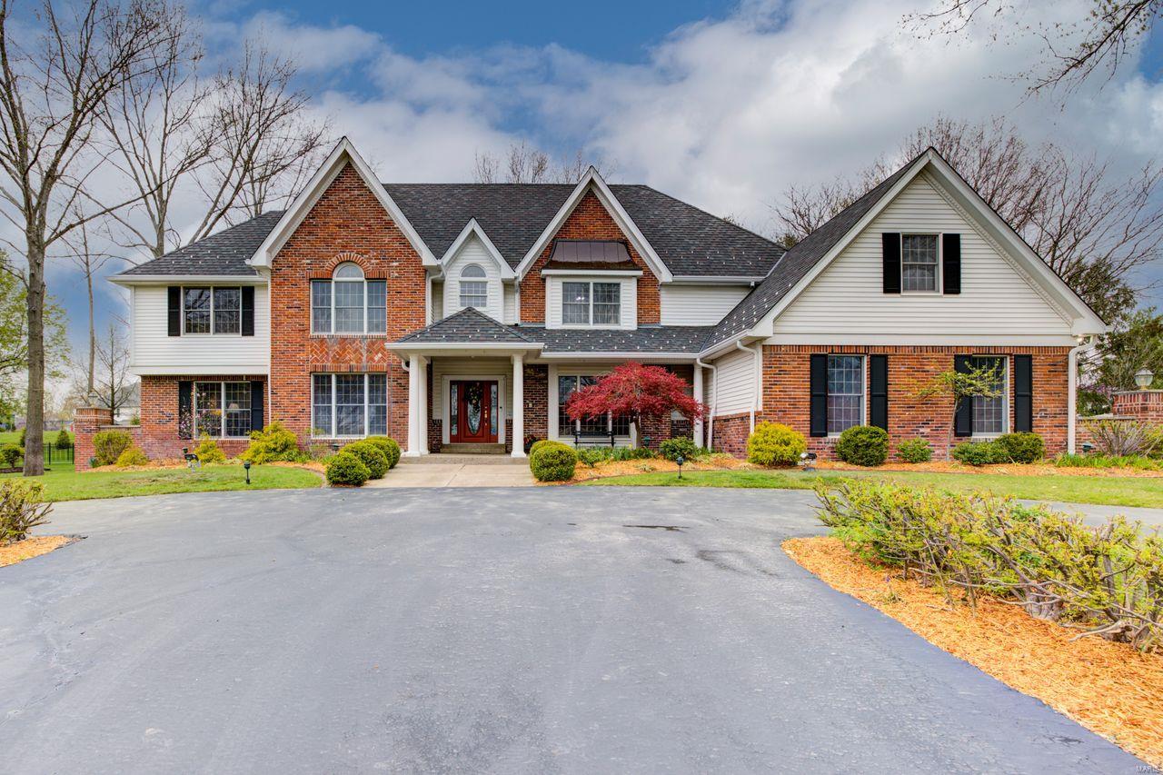 DeShetler built 1.5 story, 5000+ sq ft on 1+ acre. Beautiful 2-story Foyer & Great Rm with beamed ceiling, FP, wet bar, and double French doors leading to stone patio with built-in FP, providing an incredible entertaining area with expansive views of lush, private grounds. Off the Foyer is a wonderful wood paneled Library. The large, formal DR is perfect for holidays and family gatherings. The generous Kitchen with octagonal Breakfast Room is a chef’s dream, with custom cabinetry, granite countertops, large island and SS appliances. Beautiful Sun Rm off Kitchen w/skylights. The main floor Master Suite boasts CA Closets, Jacuzzi tub with separate shower, and separate vanities. Upstairs are 4 BRs with walk-in closets. Two BRs have ensuite Bths, while BRs 4 & 5 share a J & J Bth. There is also a Loft area which is perfect as computer space. The lower level with 9-ft ceilings has everything – Family Rm with FP, Game Rm, bar area, Wine Rm, Weight Rm, full bath and 2nd full Kitchen. Additional Rooms: Sun Room, Wine Cellar