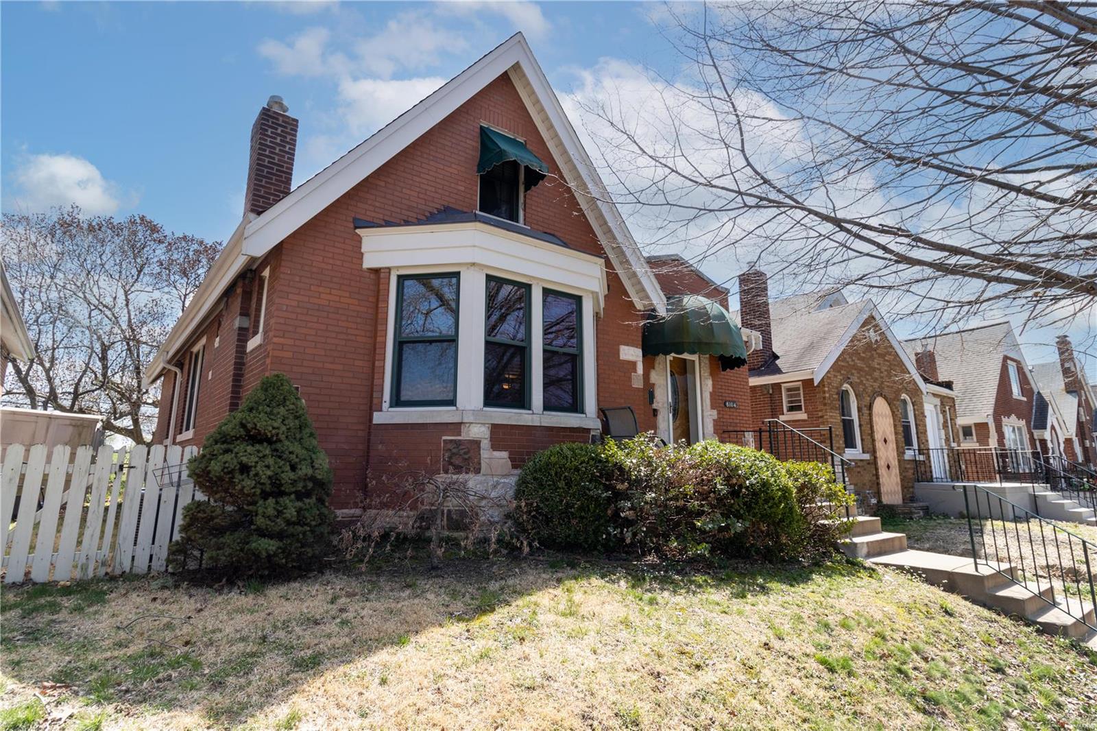 Charming, updated South City Bungalow with over 1400sq ft! There is so much character in this home with stained glass windows, beautiful staircase and original woodwork. Main level boasts a light filled living room with large windows and gas fireplace, gleaming wood flooring throughout, spacious dining room, kitchen with updated stainless steel appliances, 2 large bedrooms and a full bath. The second floor is freshly carpeted and features a large bedroom with 2 bonus rooms and a half bath. Lower level has a newly finished bathroom and plenty of space to make your own! Enjoy the outdoors relaxing on the wood deck with a retractable awning! Backyard is fully fenced and includes a detached garage. There is so much character in this home with stained glass windows, great staircase and original woodwork. Located in the heart of the Holly Hills neighborhood minutes from great restaurants, shopping and more! Updated electric panel and HVAC. Upstairs carpet installed 2022. Dishwasher 2022.