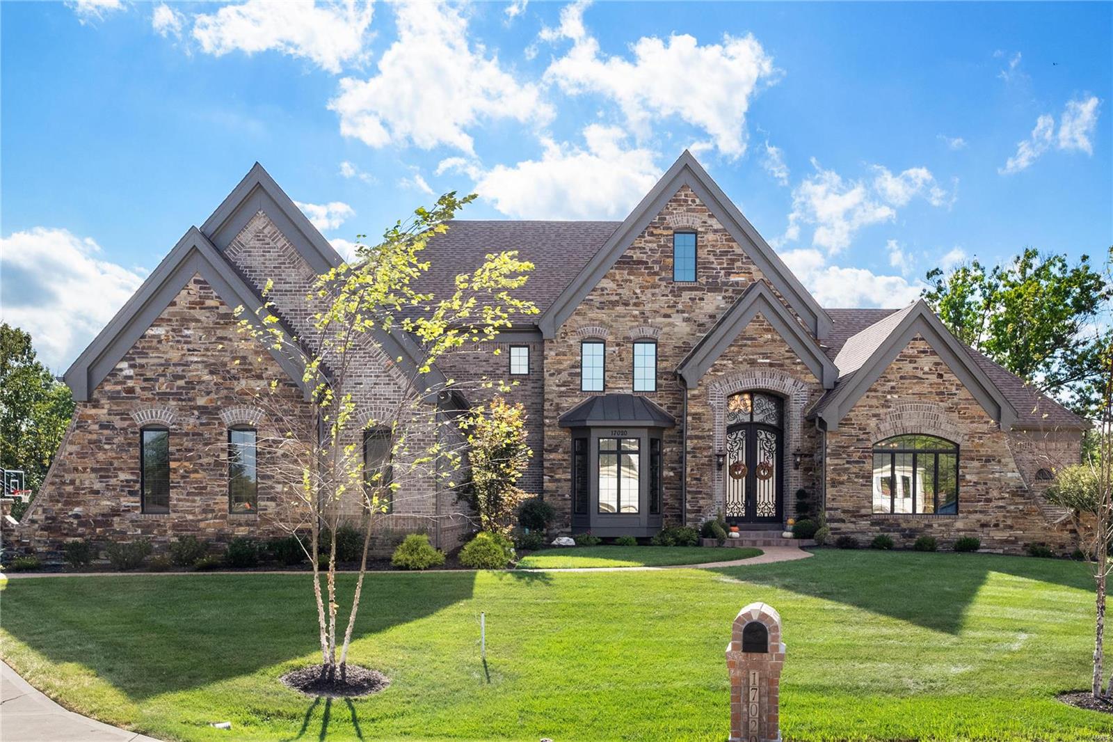 Hurry to see this spectacular home in gated enclave of 6 custom homes! This almost 6,000 sq ft estate is situated on 3 acres with 6bds/5.5 baths & newly completed outdoor paradise! Major improvements include: Geothermal heat, solar panels, water softener, custom 4 garage flooring & storage, custom blinds & amazing outdoor kitchen, stamped patio, & salt water pool w/ slide, waterfall and swim jet! Inside are 10' ceilings, 2 story entry, paneled office w/ built-ins, beautiful DR & envious master suite with wall of windows over looking the outdoor space & grounds. The high end appliance chef kitchen with 13' island flows to BR & gathering area. Great room has beamed ceiling, FP, built -ins w/ lighting & wall of windows that draws you to incredible outdoor space. Front & rear staircases access add'l 4 BDS, additional laundry, & 3 baths.  As if that is not enough; the incredible LL boasts large rec room, FP, wet bar, & 6th BD & full bath! This is the one you've been WAITING for! Additional Rooms: Mud Room