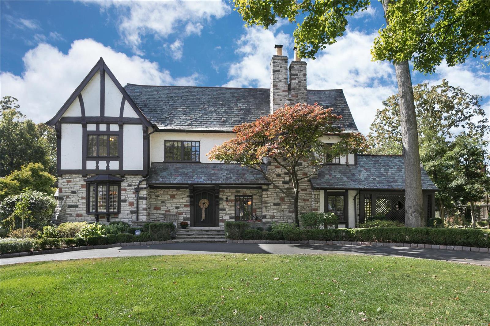 NEW PRICE! A captivating 5000+SF* Tudor home overflowing in architectural detail, character, and style. Carved beams, leaded glass, intricate plasterwork artisan detailing, throughout. The updated eat-in kitchen features 6-burner Viking Range, SubZero, extensive built-in cabinetry, and adjacent family room. The primary suite on the 2nd level features a spacious bedroom, with glassed French doors to the luxe bath, with dual vanities, jet tub, shower with bench, and heated floors. The professionally organized walk-in closet is a true room size, with an island and is perfectly set up for a future 2nd floor laundry. Two  bedrooms off stairs, one is en-suite. A large, vaulted 2nd floor family room connects to the 4th bedroom suite, a totally private suite for guests, in-laws or au-pair, with it's own egress to exterior. Breathtaking landscaping, gardens, and grounds, with a free-form gunite pool, cascading waterfall, spa and flagstone patios. *Per available Appraisal