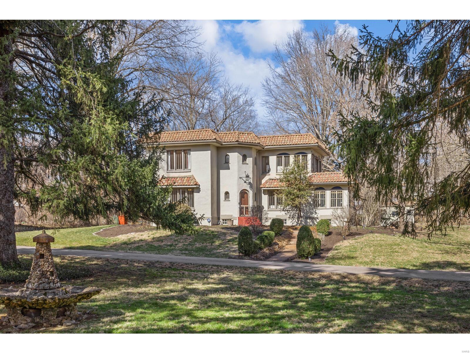 EXTREMELY RARE-Gorgeous Spanish revival manse home w/separate guest house/studio on 1.5 acres in Webster Groves.  Main home is contemporary w/vintage touches & features updated kitchen w/quartz, large pantry & loads of custom 48" cabinets & breakfast bar opens to large hearth room w/walk-out to deck & see-through fireplace; mudroom off kitchen. Family room w/custom pocket doors & living room-lots of built-ins & loads of windows w/sunlight streaming onto stunning maple hardwoods.  1/2 bath on main floor.  Upstairs 3 bedrooms, 2 baths, plus 2 balconies overlooking your private park-like grounds, Guest house w/living room, kitchen, bedroom & bath-great for guests, office, studio or in-law quarters.  Outbuilding great for workshop & storage. This private compound is true estate living in your own secluded sanctuary. just one minute walk from Blackburn park & very close to Webster University. TRULY SPECIAL!  Sq/ft includes guest house. Make your appt. Today! Additional Rooms: Mud Room, Sun Room