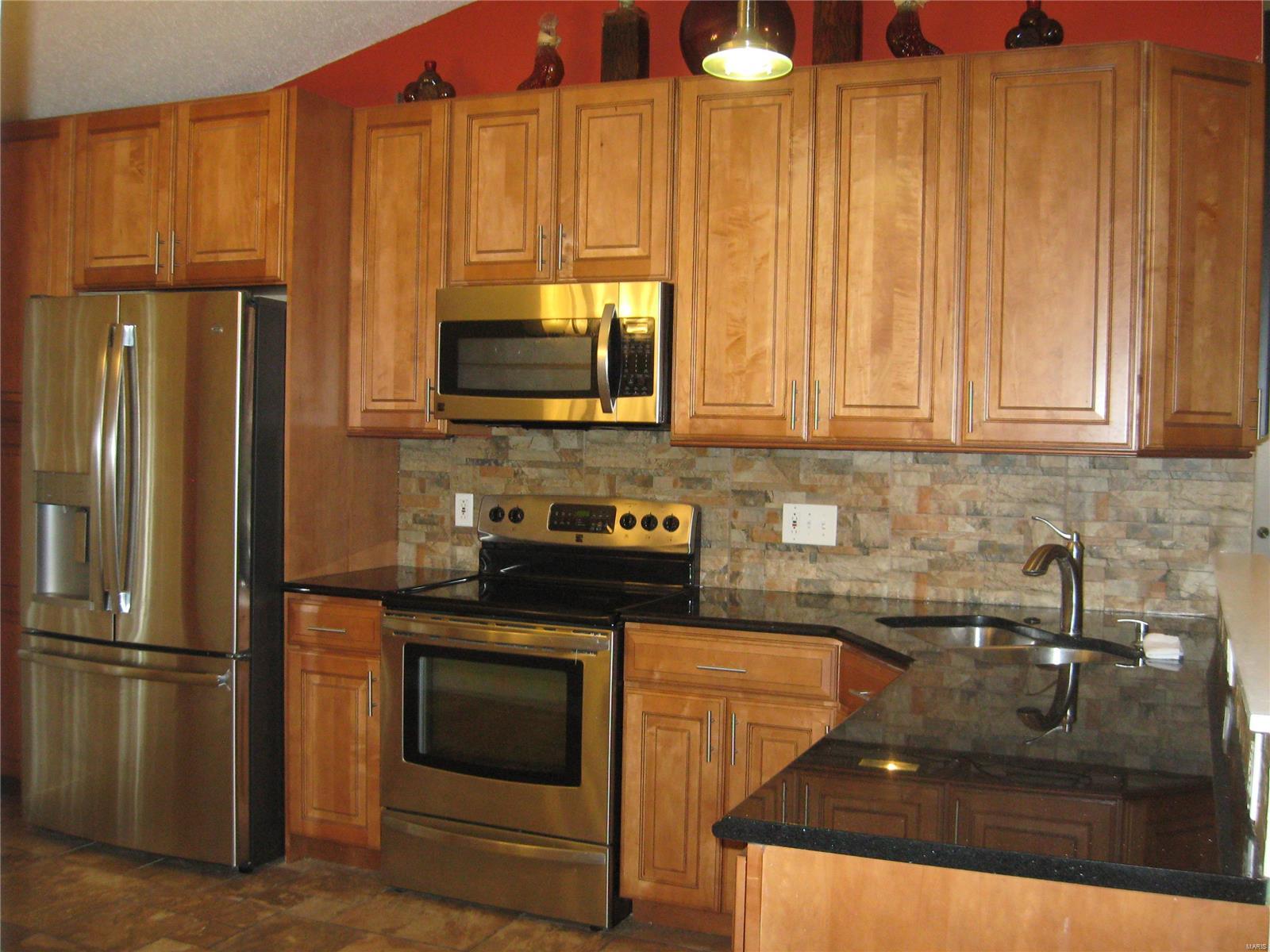 Affordable Remodeled 3 bdrm 2bath with lower level completely finished.  Vaulted ceilings & open floor plan / kitchen opened up to living room make perfect for hosting get togethers.  Living space feels huge!  Kitchen recently remodeled to include SS appliances, 42" custom cabinets, granite counter-tops, fixture & ceramic flooring sliding glass door off kitchen to backyard.  Walk-in cedar closet located in LL were possible sleeping area could be utilized.  Two more separate areas in LL could be used as media/sitting room & or Rec rooms.  Some newer windows throughout & light fixtures.  Ceiling fans in all bdrms. New paint throughout house.  Ask your Agent about possible credits/concessions.  **Very motivated Seller so hurry - otherwise could be gone quick!**