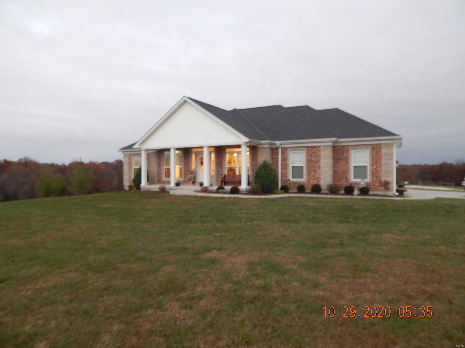 Beautiful 1967 sq ft. 4 bedroom 3 1/2 bath built in 2015 sitting on 5.61 ac gorgeous ac with Black top frontage. The home has an open floor plan, custom Amish Made Hickory Cabinets & Hickory Hardwood flooring, amazing black Granite Countertops.  The master bath has a  custom tile walk in shower & a separate tub for soaking. Gorgeous Windows with some custom blinds. The 3/4 basement is partially finished and offers a bar area with a living area. Would make great entertaining space. The home has a Geothermal system and is currently hooked to a well but county water is across the road & could easily be converted. Offers a 2400 Sq ft detached garage that has a propane furnace, a kitchen area & bathroom. All concrete floor. The property is fenced & suitable for horses. Call to make your appointment today