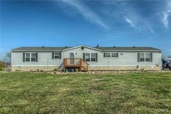 Welcome to this SUPERBLY MAINTAINED home situated on over 3 acres. Upon entering you will be greeted with a sense of SPACIOUSNESS provided by the OPEN FLOOR PLAN & VAULTED CEILINGS! A GORGEOUS stone fireplace is the focal point of the Living Room. The sunny breakfast room area is situated just off of the living room. The adjacent ADORABLE Kitchen provides plenty of cabinet space & BREAKFAST BAR. The Dining Room with it's LOVELY windows is the perfect spot for entertaining. The MASTER BEDROOM SUITE is an OASIS with it's JETTED TUB, SEPARATE SHOWER, HIS & HERS VANITIES & WALK-IN CLOSET. Two additional NICE SIZED bedrooms are situated at the opposite end of the house. The cozy Den is with it's BUILT-IN CABINETRY & DESK AREA provides an excellent work space. Attractive laminate flooring covers the main living areas. Rear entrance is conveniently located in Laundry room/Mud Room. The oversized garage/utility shed provides plenty of storage and/or work space, & has TWO HORSE STALLS attached. Additional Rooms: Mud Room