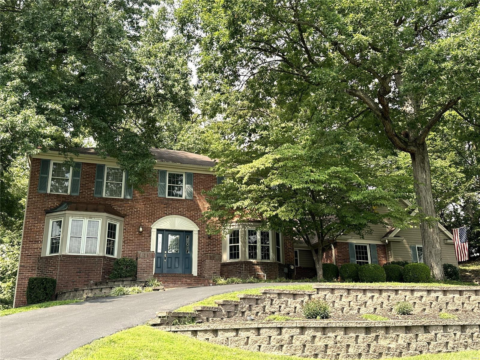 WOW 2 STORY HOME IN DESIRABLE FOREST HILLS!! BACKS TO VALLEY COURSE! APPROX 5,000 SQ FT TOTAL LIVING AREA. SO MANY UPDATES & FEATURES & MAJOR ADDITION CREATING OPEN FLOOR PLAN! Beautiful hickory floors thru-out main level. Updated kitchen-6 burner gas cooktop w/hood, warming drawer, Dacor appliances, center island, softclose drawers & doors. Opens to the lg brkfst room w/lots of windows overlooking the beautiful treed backyard! Main floor has so much entertaining space-large great room w/beamed ceilings, built-ins, brick fireplace, additional sitting room AND LARGE BAR AREA perfect for game day get togethers. Sep dining & DEDICATED OFFICE on main level. Updated walkout LL-rec room & game room perfect for relaxing, watching a movie or playing games! Wet bar, fireplace, 1/2 bath, large storage closet + unfinished storage too! Updated primary bath, 3 HVAC zones, circular drive, 3 car side entry garage, lg patio & deck. Easy walking distance or take your golf cart to the private club!