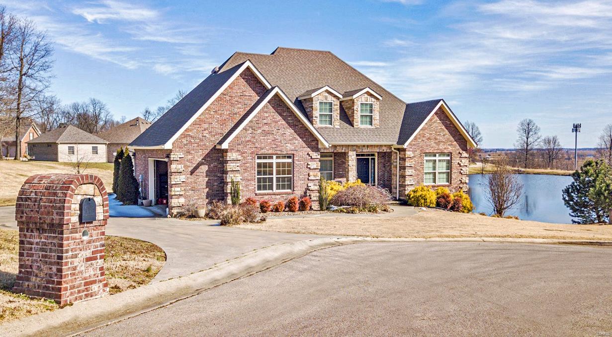 You'll find winding streets that lead to this impressive all brick & stone home! As you enter this gorgeous home, you will notice the open concept living areas & light filled rooms, complete with high end engineered hardwood flooring. The chef kitchen is sure to catch your eye, it comes with stainless appliances &amp; spectacular marble countertops. The living rm offers 2 sets of glass doors that allow flow onto the patio areas. There is a formal dining room, along with a breakfast area. Main level owners suite is a private retreat with balcony, bath offers upper end finishes, ( jetted tub, tile shower, dual vanity, granite top), Lg walk in closet has custom shelving &amp; drawers. Upper level boast a 2nd living area, along with additional bedrooms &amp; bathroom, walk in attic is floored.  Lower level is partially finished, kitchen cabinetry is set. 2 Hvac units. Security system. Panoramic pond view. Covered open decks. *1/2 bath not finished.