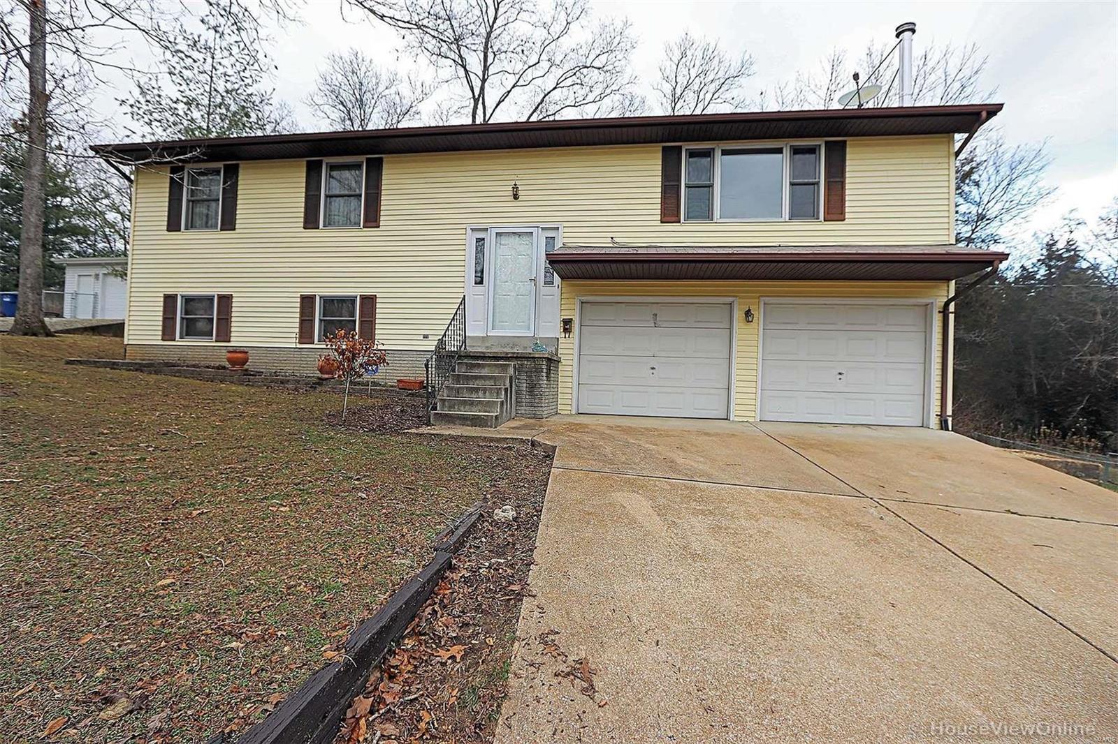 Large home with over 2,200 sq. ft. on a corner lot with a fantastic view of the Lake across the street. This home has 4 bedrooms, 2 1/2 baths, large master bedroom with bath. Large family room, large laundry and 1/2 bath in the lower walk out level. Storage shed and fenced back yard. Large deck off of the kitchen area with french doors. 2 car attached garage. Great location!