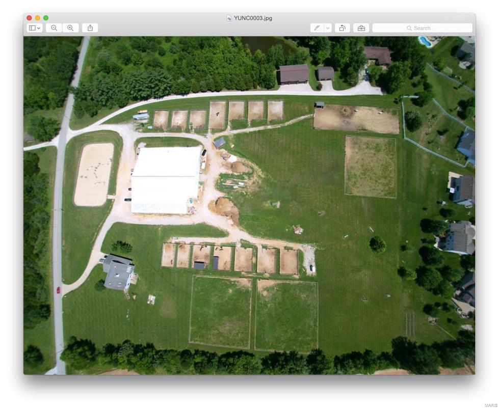 Great opportunity to own a turn-key horse operation. Est over 26 years ago & withstanding the ups and downs of the market trends. Perfectly situated, in the heart of the St. Charles Equestrian community—3 miles to two major hwys, 2 miles from the National Equestrian Center makes filling your lesson program a breeze. Sale includes 4 large pastures for grass turn-out, 12 all weather paddocks with cross-fencing and electric fencing, cross-country jump fields, and 4 bed house. 20,000 sq feet of building encompasses 40 stalls all with automatic and freeze-proof waterers, 2 hot/cold wash racks, 2 bathroom & laundry facilities, storage for hay, viewing room, 2 feed rooms. Indoor arena is 140 ’x 80’ and attached to barn aisle-way keeping boarders happy that even in winter they can always ride and turn out horses. This all-weather facility built to withstand the extreme cold and high winds. Outdoor arena is 172’x90’ fenced and crowned for quick drainage & nearly year round use. See drone video