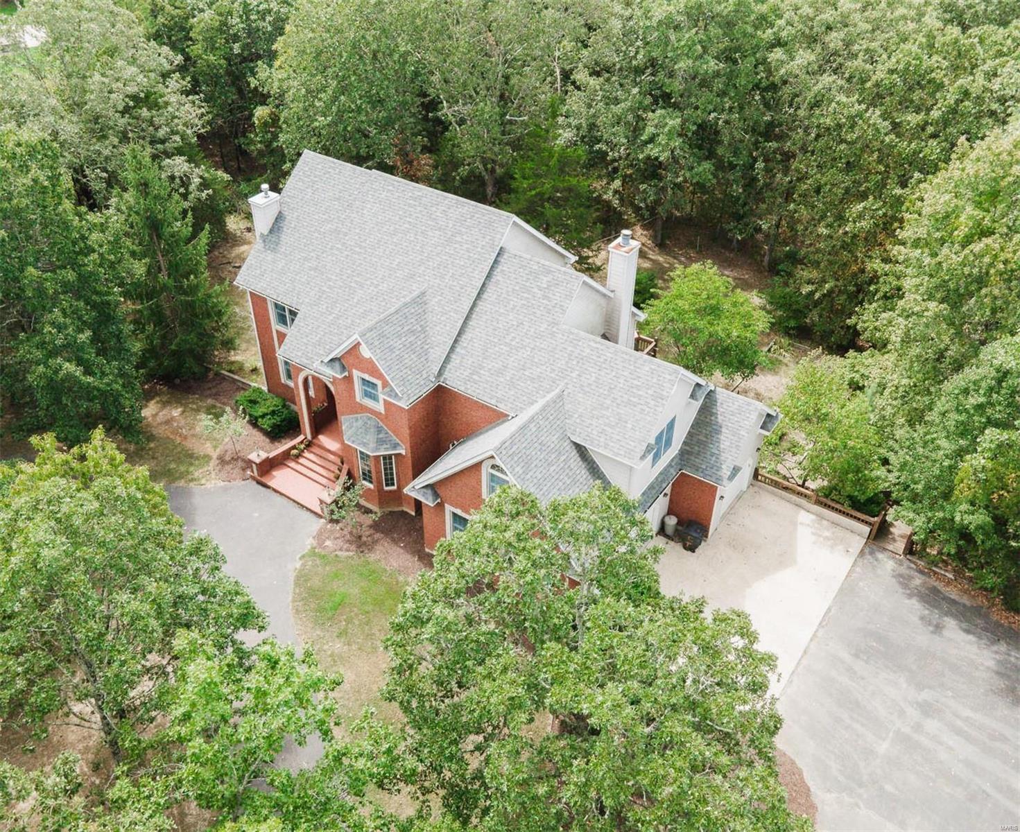Find your OASIS tucked beside the trees just outside Rolla MO near the Golfcourse! This beautiful 5 bedroom/3.5 bath home rests on over 2 acres and offers a luxurious layout w/plenty of space to live comfortably. Hardwood floors on the main level, along with 2 fireplaces, formal living room and dining space AND cathedral ceilings in the cozy family room - it's a wall of windows for daytime lounging. Kitchen has tons of storage, center island, double oven and a great eat-in space surrounded by more windows. From there, you can walk out to the large deck that wraps around to the 3-car garage, or you can head upstairs to retire to your large 24x18 master bedroom w/ sitting area and 3 more bedrooms w/ a separated floor plan. Master bath has a whirlpool tub, separate shower and dual sinks and it leads to 2 walk-in closets. The basement has a very spacious mother-in-law suite w/ kitchen, bath, bedroom LR and family room. It walks out to a patio and has a private entry if needed. Call to see! Additional Rooms: Mud Room