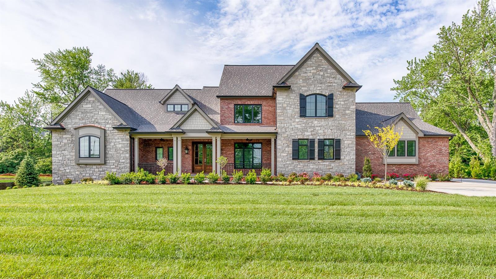 The home of your dreams! 5,800 SF New construction by Mark S Homes. 1.5 story brick & stone residence sits on nearly 1 acre in the heart of Frontenac. 5 BR/5.5BA,  Spacious open plan perfect for family & entertaining; outdoor rm with fridge & grill; Mahogany front door w/wide foyer leads to vast heart-of-the-home lr-kit-fam rooms w/great sidelines.  Fine details abound: tray & vaulted ceilings, dark hardwoods, arched entries, Pella windows, 2 Frplc,custom finishes & beautiful lighting.  Gourmet kit opens to a dramatic hearth rm w/ full stone Frplc. Center Island kit w/breakfast bar plus a separate breakfast rm, Custom cabinets, stylish range hood, beautiful backsplash, Wolff/sub-zero appl. The 1st floor study is adjacent to lovely master en suite. 2nd FL overlooks living area, 3-ensuite BRs.  LL: huge fam rm/wet bar & fridge, 5th BR & BA plus over 1500SF of unfinished space; 3-car gar, dbl-wide drive provides ample parking. Fully landscaped yard w irrigation system & outdoor lighting. Additional Rooms: Mud Room