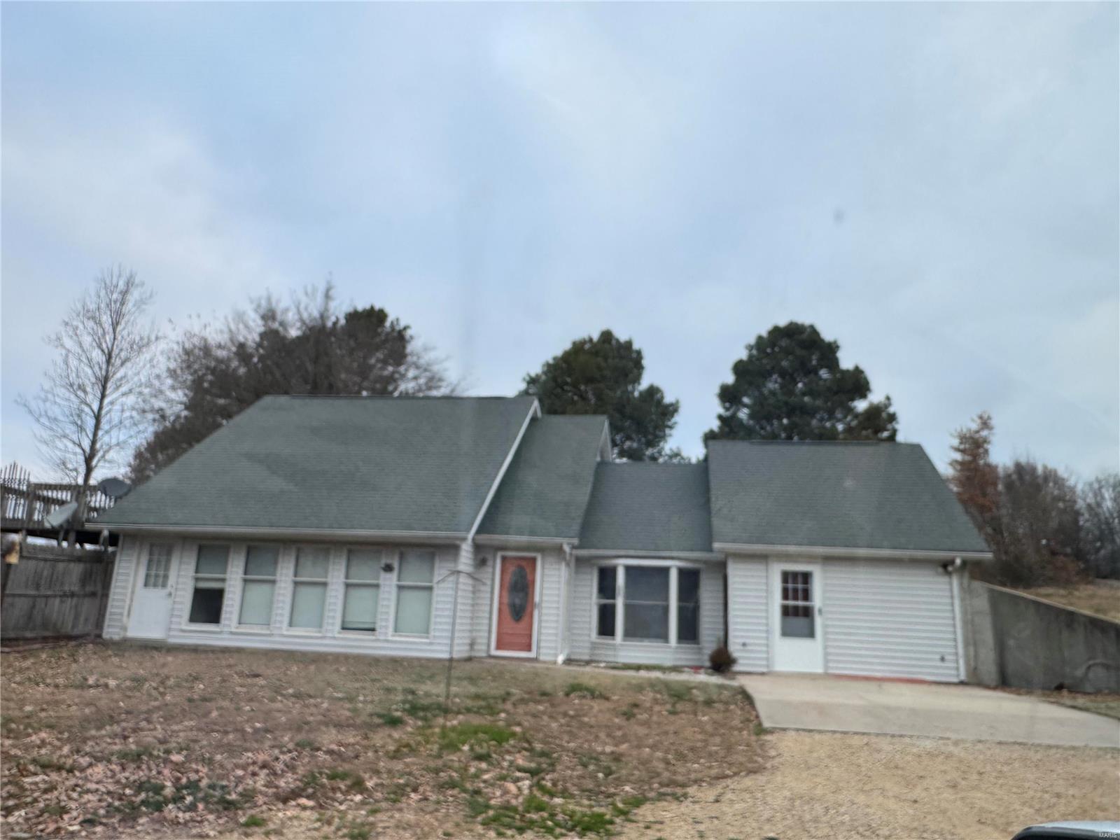 A rare chance to get a custom-built earth contact home on a spectacular 1-acre lot for nature lovers.  A lovely home perfect for a family who would like privacy but the convenience of minutes from town. It has a large 20' x 24' shop with 2 sliding barn doors, electricity, a concrete floor, plus a bonus tool shed with lots of shelving. This home has a large wooden deck off of the top floor. Perfect for entertaining or everyday living and a large level back, front, and side yard. Large enough for a swimming pool if desired. The current owner is in the process of updating! Make an appointment today to see this stunning home!
