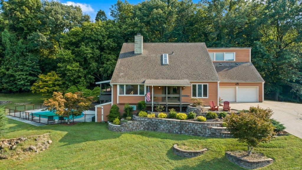 Located in one of Cape Girardeau's most picturesque neighborhoods, this 5 bedroom/4bath John Boardman designed home on 1.63 acres is full of character and upgrades- including a double-sided fireplace, vaulted ceilings, skylights, and 42" professional range. Privacy is a luxury and 616 Peironnet backs up to mature woods, a quiet street, and is a quick drive to enjoy all that downtown Cape has to offer.
If you're an outdoor enthusiast, the swimming pool and tennis courts will allow you to enjoy your home year-round as you entertain from the fully equipped and covered outdoor kitchen with plenty of room to spare for a garden. If your idea of entertaining is more along the lines of cocktails by the pool, you can sip your favorite drink from the covered patio off the dining room and enjoy the park-like setting and neighborhood landscape. 
This home is a must-see for anyone who loves design and is searching for a custom home with character where they can add their own personal touch. Additional Rooms: Sun Room