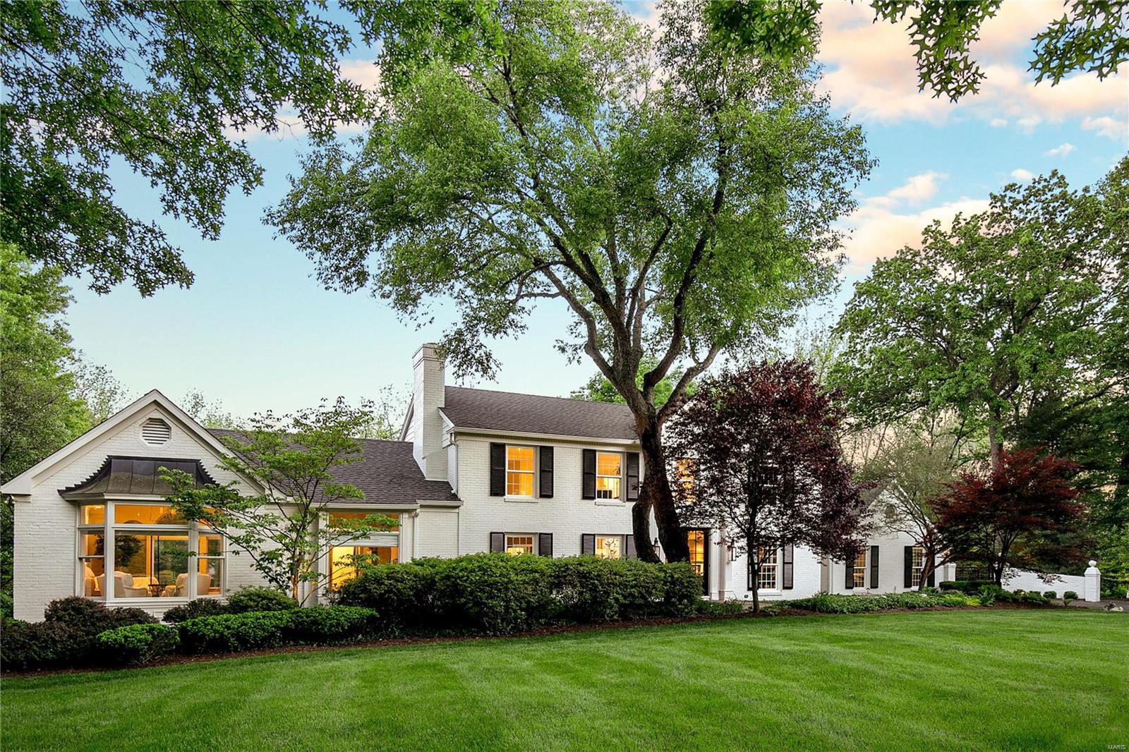 Est. 1966. SEE VIDEO. Thanks to extensive landscaping & mature trees this 1.8ac estate on a corner lot in Ladue feels very secluded. The saltwater swimming pool is surround by tiered landscaping for exceptional privacy. Romantic gas lanterns guide you through the front door to find a space worthy of Architectural Digest's front cover. The living room & family room open to one another, each with a fireplace trimmed in Carrera marble. The Sunroom overlooks the park-like grounds and leads to a brick-paved patio. Kitchen finishes include Patagonia granite and a copper tile backsplash while the recently reconfigured cabinetry & appliance layout leaves you wanting for nothing. A gallery leads you to a large main floor master suite with vaulted ceilings and walk-in closet. Upstairs are 3BR and 2BA including a 2nd ensuite. The lower level has a rec room, gym, & 2 baths. Additional features: 2 car garage, 4 car parking pad, gated driveway, gated dog run, fenced yard, composite deck, & new roof. Additional Rooms: Mud Room, Sun Room