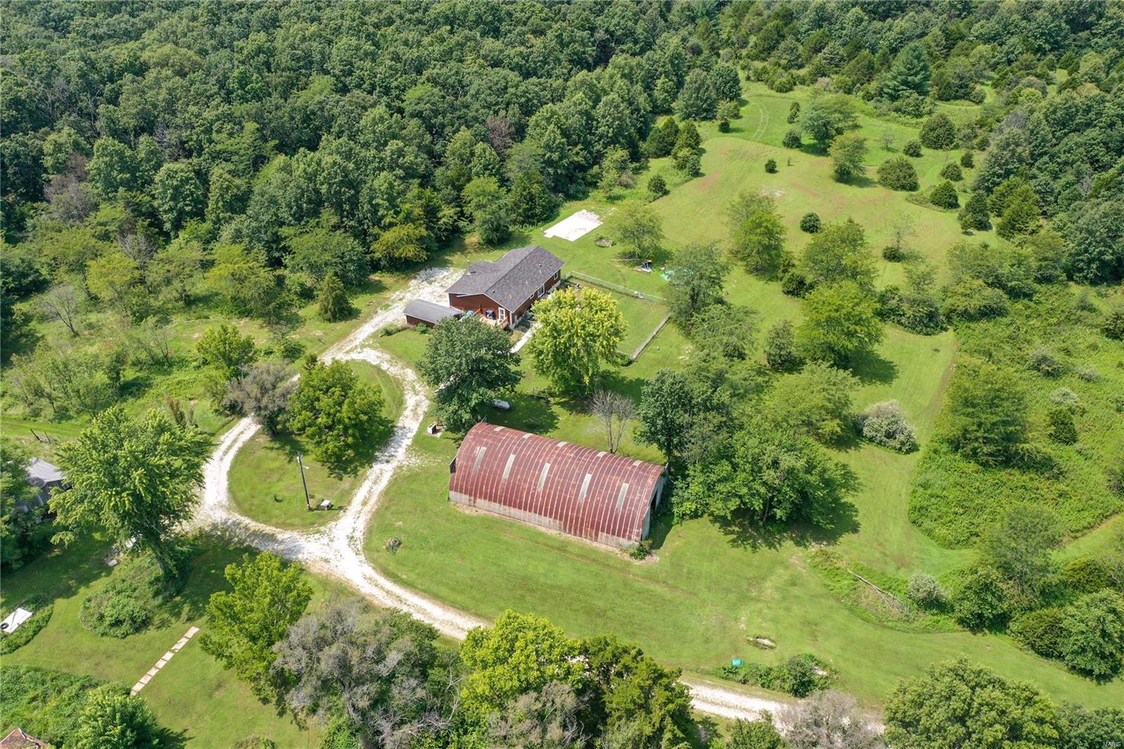 Welcome to your dream property, a breathtaking 165-acre estate that promises a perfect blend of nature & modern living. This incredible slice of heaven, spanning Montgomery & Warren counties offers 2 ponds, & an expansive wooded area w/trails ideal for exploration, hunting, & connecting w/nature.Several outbuildings including a spacious Quonset hut.There are 47 acres of tillable land. The updated modular home is a haven of comfort, featuring a composite deck, perfect for outdoor entertaining or simply soaking in the stunning views.The free-standing woodburning stove on the main level adds warmth & charm to the large living rm.The walk-out basement offers a full kitchen, living rm, sleeping area, bathrm, dog washing station & storage.This property is being sold as-is & with tax id 01-28.0.0.00.006.000.000 Warren County offering a unique opportunity to own a piece of paradise with endless possibilities. BOTH tax records total 165.12 acres.Don't miss this extraordinary opportunity! Additional Rooms: Sun Room