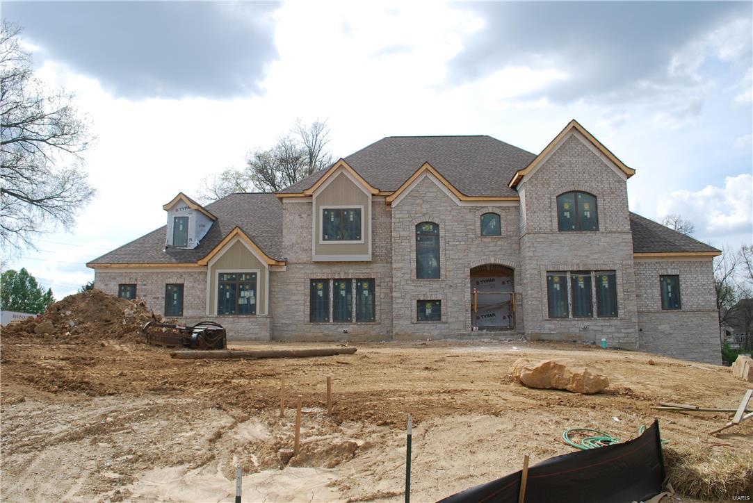 Approx. 5,800 sq. ft. custom home has luxurious master and guest suite on the main level. Kitchen, breakfast rm and hearth rm flow together into a large spacious heart of the home. The great rm opens directly from the 2 story foyer, with views to the private treed rear. Dining rm and full paneled study open from the foyer and main hall. Laundry rm and mud area have direct access from the service porch and 4 car garages. First floor has a minimum of 10’ceiling height with many rms having coffered or vaulted ceilings above 10’-0. First floor also has 8’ tall doors throughout. Exterior veranda included.The second floor has 9’ceilings which will have 3 full bedroom suites with private bathrooms & walk-in closets along w/bonus rm. Basement will have high ceilings. Timeless front exterior w/mixture of stone & coordinating brick, a  4 car side entry garage, and large level backyard w/mature trees & privacy. Interior photos reflect Rehnquist Craftsmanship & do not represent actual property.
