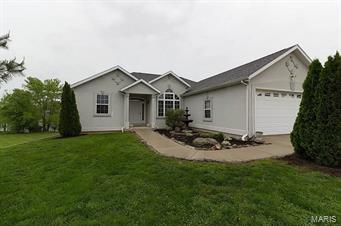 Experience this amazing home up close and personal. This one absolutely has it all!  From the initial curb appeal featuring beautiful landscaping surrounding a lovely home to the initial WOW upon entering inside to see the soaring ceilings and hardwood flooring.  This home has over 3000 square feet of living space with tons of extras including a 21x19 storm shelter along with a nice size John Deer room. The ranch design features a nice size living room with fireplace, open dining area, ample counter space and cabinetry along with a breakfast nook, laundry with tons of shelving, 4 bedrooms, 3 full baths, hobby/game room, HUGE family room all of which is providing plenty of space and privacy for your family or guests.  Some amenities:  Lake front with private access-fishermen will love stocked lake-house prewired for home security system-high efficiency HVAC unit means low cost utilities-high R Value insulation installed-new roof 1.5 years old.