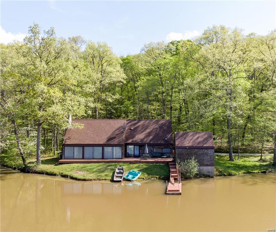 If you're looking for privacy and seclusion you've found it here! This property is the perfect weekend retreat and features a 1.5 story home with 3 bedrooms and 2 baths. This is all nestled privately on 117.88 wooded acres in the heart of Augusta wine country with a stocked 9 acre lake.  You can enjoy views from the deck, the dock or just sitting in the great room with large windows overlooking the lake.  You'll be cozy in the winter too with the stone fireplace to keep you warm.  There are wood floors and wood cathedral ceiling to add to the cozy setting.  There's also the option of building your own custom home!