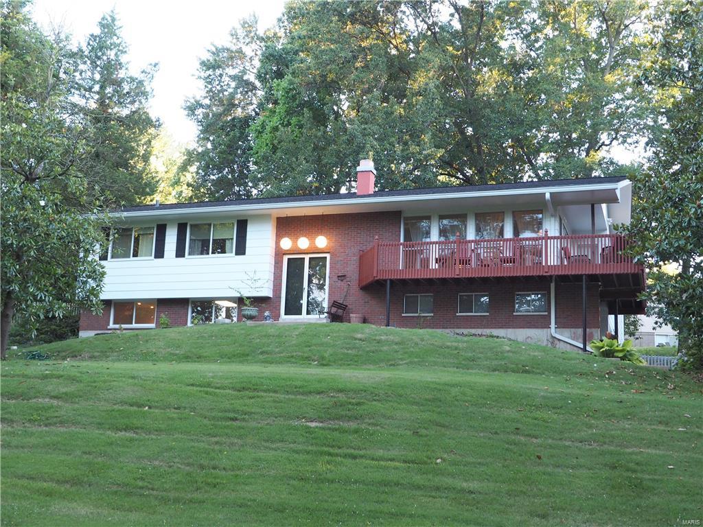 Just WOW! Expansive 5 bedroom 3 full bath renovated home sitting on 1.4 acres! Unique touches throughout including updated kitchen with copper (naturally antimicrobial) counter tops, loads of cabinets, upgraded appliances, fixtures and lighting.  Beautiful newer flooring through most of main floor. A wall of windows fills the formal living room with natural light. 2 wood-burning fireplaces. Custom bathrooms with never seen before vanities. Master suite with walk in closet and a fantastic private bath straight out of Architectural Digest! Huge soaking tub and walk in shower. Giant lower level rec room with wet bar AND enormous unfinished storage area. Wrap around deck overlooks the gorgeous lot and patio out back for entertaining. Other updates include newer roof, 200 amp electrical panel with whole house surge protector. 2 car garage, storage shed and plenty of parking for additional vehicles. There is nothing like it- It's awesome!