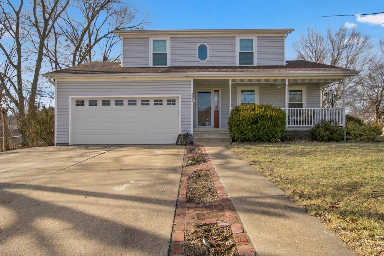 Act fast to see this beautiful 3BR, 2.5 BA home with 2 car attached garage.  This spacious home showcases a roomy kitchen w/updated cabinetry, plenty of counter space, center island and double oven.  Also boasts main floor laundry, dining/breakfast room area and sunny office area that could easily be a formal dining or sunroom. Upstairs you will find master bedroom suite and two additional bedrooms.  Full walk-up basement features full rough in bath and vault room. Outside you will find two patio area, large level yard, detached 2 car garage and extra-large concrete pad to park all the family toys.  Spend the afternoon relaxing on the covered front porch. This home is move in ready and offers many extras hard to find, so don't wait to call for a showing before it's gone fast!