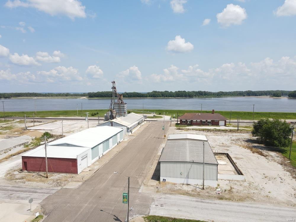 Prime commercial opportunity!  This 1.62 ac tract offers warehouse & retail space & has been home to Canton MFA for many years: 

Building #1 – This 6902 sq ft building is the current storefront, warehouse, fully operational scales, and old feed mill equipment and storage, cement floor with cement  block walls and loading docks.

Building #3 – There is a brick sided shop on the west side of this building (1,300 sq ft) with 5,200 sq ft of warehouse space, metal building & roof recently new, cement flooring with several loading dock areas.  Excellent warehouse facility.

Building #4 - This has 1,040 sq ft garage bay with clean-out pit, 2,800 sq. ft. of warehouse space with heated room (electric) for temperature-controlled products. Metal siding and roof with cement floor and loading dock area. Location: City, Downtown, Industrial Area