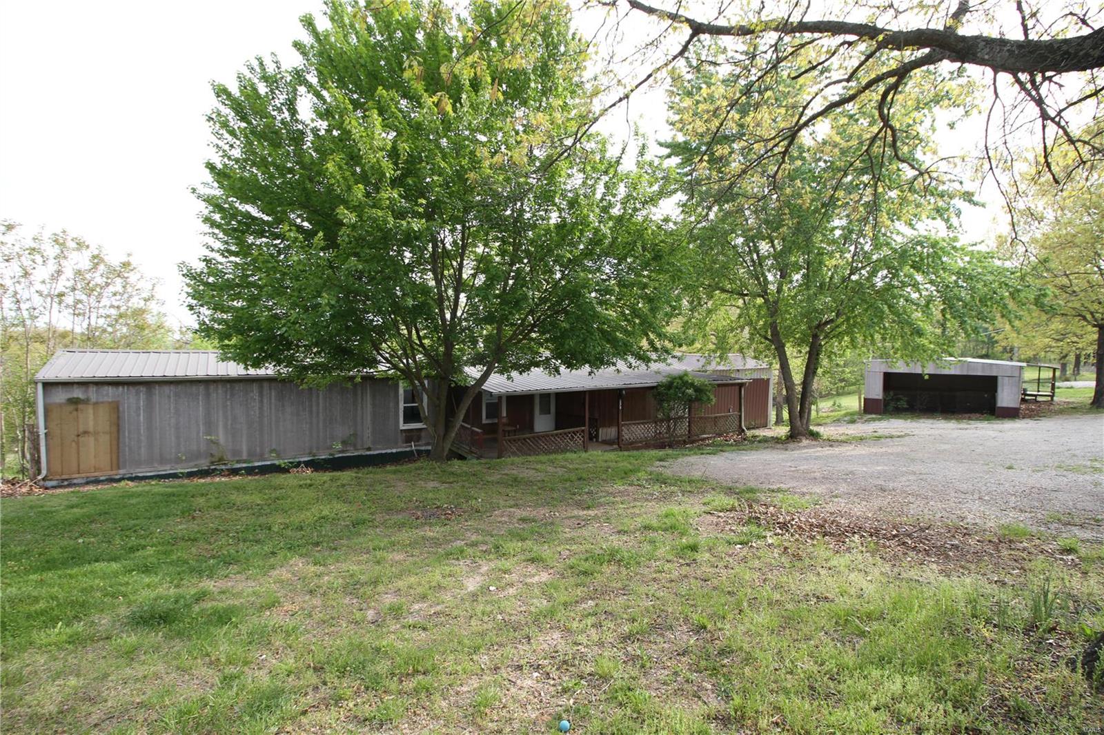 POSSIBLE 5 BEDROOMS!!! Calling all investors and DIY enthusiast!  *Possible Package Deal with the home next door and behind the property on almost 5 acres total!* No showings without an agent please.  This home has tons of space and a HUGE sunroom off of the back half of the home. There are so many possibilities!  The two homes up front and in back all share the same driveway but that can be resolved very easily. The two homes also share a well, but we can negotiate that too! Remember to check out the oversized 2 car garage. A survey will be completed prior to closing to split the properties. Otherwise, selling as-is. Well pump, wires, lines and pipe all recently replaced. Home previously had renters but has only been vacant since March. At this low, low price, you can afford to make the home exactly how you've always dreamed! Make an appointment today! Additional Rooms: Sun Room