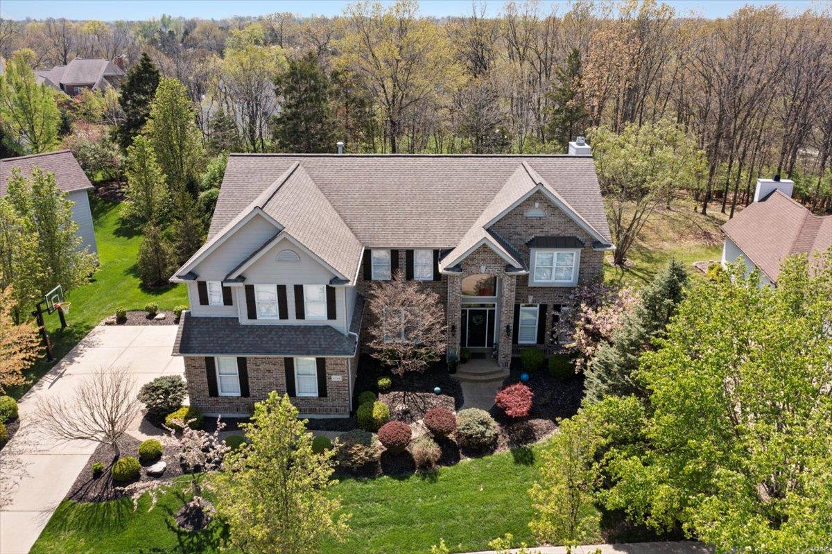 This beautifully updated home offers over 4,800 sq ft of luxurious living space in a prime location within the Rockwood School District.  Main level & upper-level feature gorgeous hardwood floors throughout.  Formal dining & private office w/ crown molding, a spacious Great Room w/ WB fireplace and custom built-ins, and a gourmet kitchen w/custom cabinetry, granite counters, stainless appliances, a two-tier island, pantry, and breakfast room. The vaulted Hearth Room opens to a private, park-like backyard. Upstairs, the vaulted primary suite boasts dual walk-in closets & a spa-style bath with granite and a soaking tub. Three additional bedrooms, two baths, & a loft complete the second floor. The finished LL includes a rec room, wet bar, media room, family room, & full bath. Add. highlights: Zoned HVAC & filtration system, custom moldings & window treatments, 3-car side-entry garage, Irrigation & exterior lighting, Close to shopping, dining, parks, -this is luxury living at its finest.