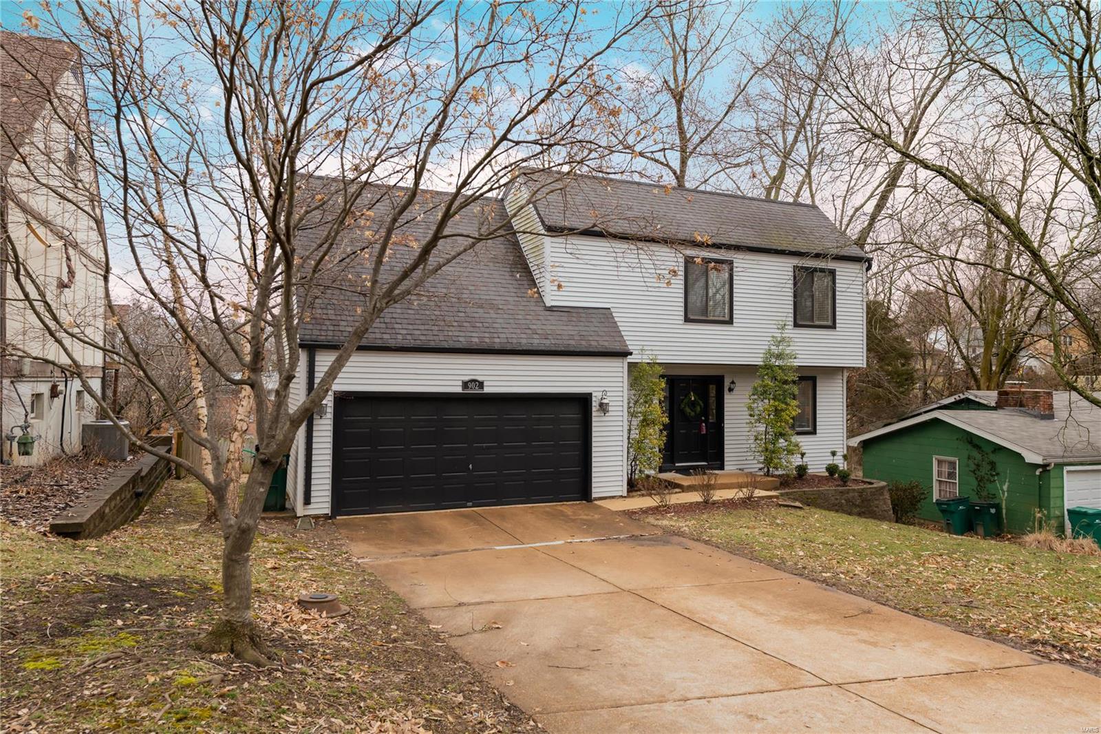 The traditional Webster floor plan you love in a 2 story home that is only 34 years old.   No worries about clearing ice and snow from your cars because this home has an attached 2 car oversized garage with direct access to the kitchen.  The main level has a nice sized living and dining room combination plus an updated kitchen with granite counters and newer appliances.  A thermal door off the kitchen leads to a large deck overlooking the private fenced yard.  A half bath is off the entry hall for guest use.  Upstairs are 3 bedrooms and a full bath plus a storage room.   The master bedroom is on the opposite side from the other 2 bedrooms.  The walk out lower level has a large family room and separate storage area.   Another sliding glass door leads from the family room to the yard.   Conveniently located in the Tuxedo Park community close to Webster University, Old Orchard, shopping, restaurants.