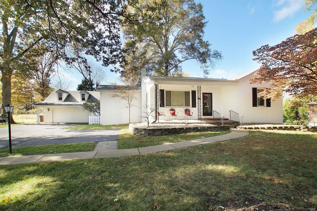 This cozy cutie is ready for you to make it home! Sitting on nearly 1/2 acre with gorgeous, mature trees, a LARGE and level fenced backyard, this charmer is loaded with character! Relax on your inviting front porch, enjoy hardwood floors in the main living areas, host family dinners in your separate dining room area with slider onto your large 20x12 deck, relish the updated kitchen w/ stainless steel appliances, marble floors, pendant lighting, breakfast bar and pantry. Main floor master, plus 2 nicely sized bedrooms w/ ceiling fans and 3 y.o. neutral carpet, plus the generously sized main floor full bath. The basement is unfinished, but ALREADY framed and could be finished for even more living space.  2nd full bath is already installed in basement. Additional basement workshop area could also be finished to make a great home office or additional sleeping room. Built-in basement storage shelves for your convenience. LARGE detached 2 car garage w/ lots of storage. Hurry!