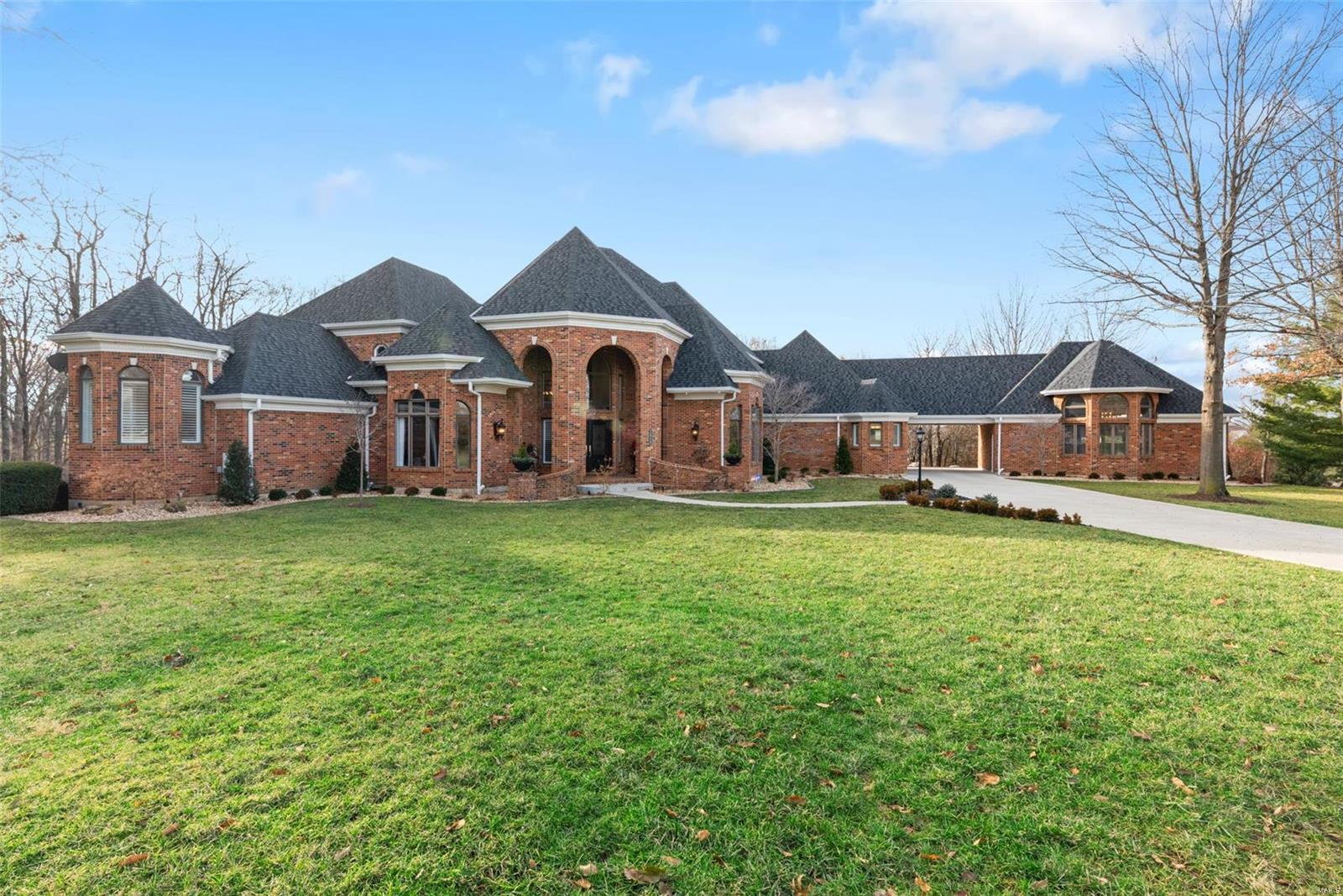 The epitome of luxury living in Lake St. Louis! This enchanting, all brick estate sits in a private cul-de-sac on 3.8 acres & raises the bar for curb appeal. Step inside to find over 8,000 sqft of sprawling spaces w/soaring ceilings & high-end finishes. Every detail was carefully selected when the home was completely updated in 2018. The chef’s kitchen features quartz countertops, Wolf appliances & SubZero refrigerators. See-thru fireplace separates the breakfast rm from the great rm. Retreat to the main floor master suite w/sitting area, 2 closets, built-ins & heated bathroom floors. Entertaining is easy in the finished walkout basement complete w/ a two-sided fireplace, billiards rm, living area, workout rm & custom wet bar. The outside is equally impressive w/ a new saltwater pool, pavilion, firepit, large yard, shed & composite deck. The attached 3 car garage w/breezeway leads to the 2-car carriage house finished w/ epoxy floors & a full bath. *Optional lake rights & LSL amenities. Additional Rooms: Mud Room