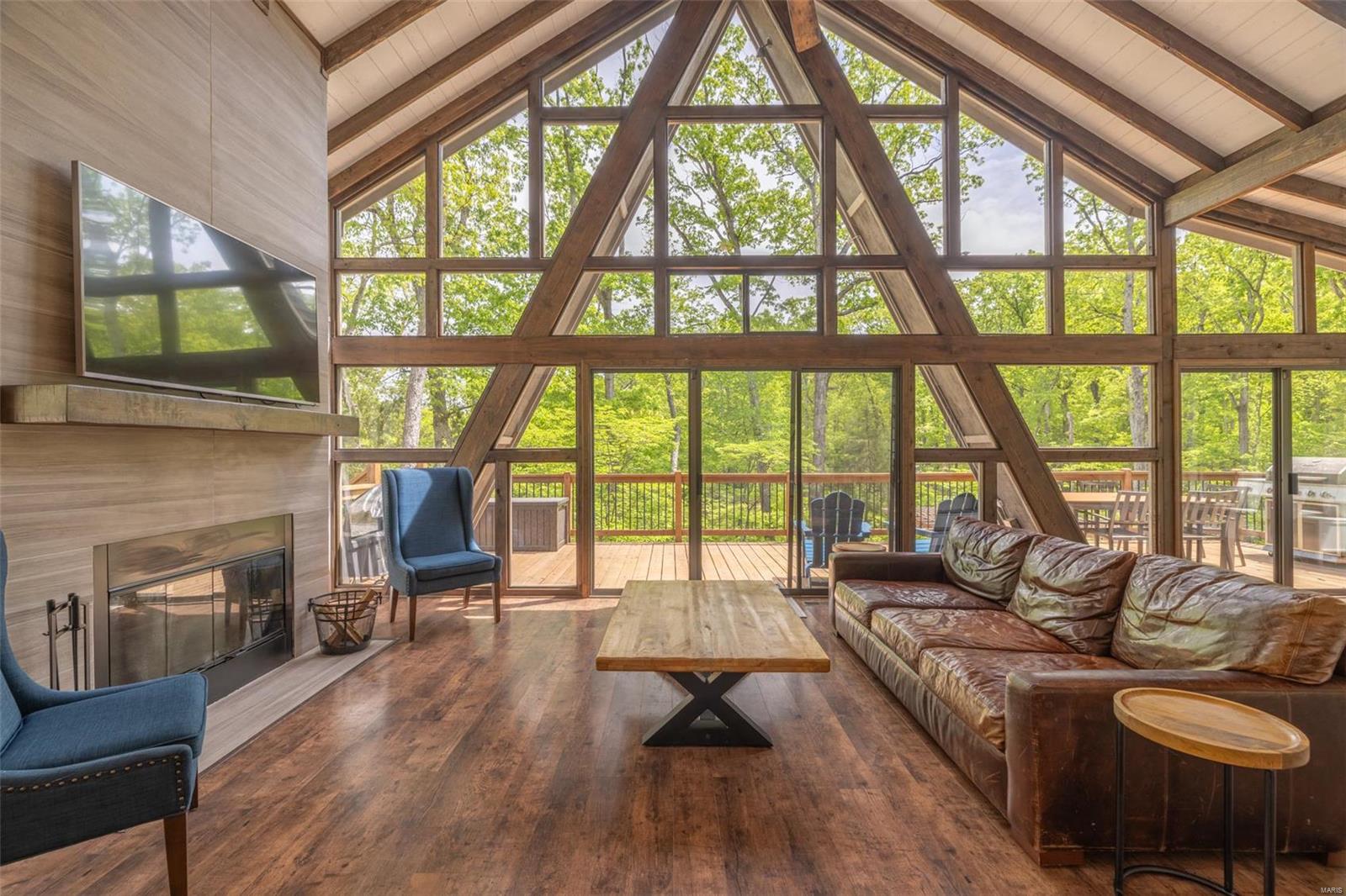 Your premier home away from home awaits in this first-class, 4 bedroom, 2 bath chalet located on the shores of Lake Silveretta! This chalet screams luxury, with vaulted ceilings and contrasts of stained wood accents throughout the home. Paired with an abundance of privacy and located only moments away from all of Innsbrook’s amenity hot-spots, this home hidden in the woods provides the perfect getaway to unplug and unwind. Once inside, you are welcomed by a fully equipped kitchen to entertain featuring a center island, stainless steel appliances, a spacious living room, dining area, wood burning fireplace, cozy sun room, upscale furniture, washer/dryer, and panoramic views of Mother Nature’s playground. Step outside to the expansive deck, offering treehouse vibes. Take a few additional steps to enjoy your private patio equipped with an oversized fire pit, pergola, and walkway providing easy access to your lakeside oasis. This featured property is a turnkey sale. A true must-see!