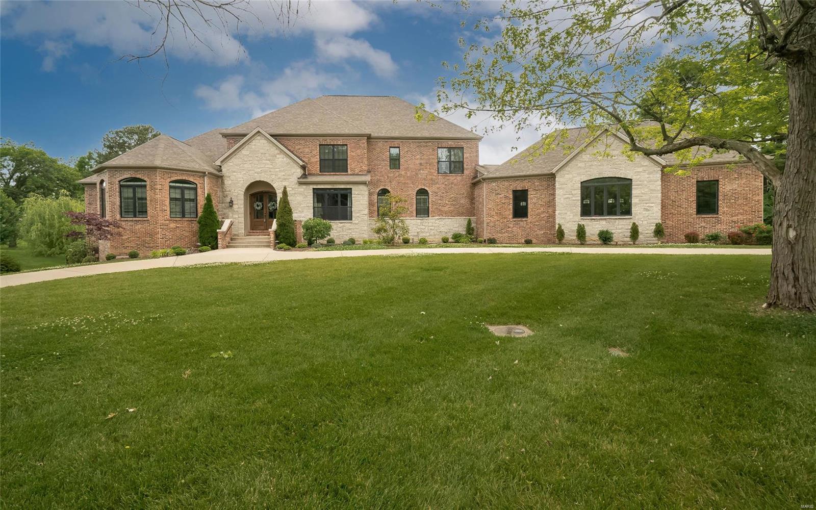 5 years new, expansive stone and brick home in Town & Country! Excellent Location, walking distance to Town & Country Town Square, Starbucks & Long View Farm Park.  7 bdrms, 7 full baths, 2 half baths w/extensive architectural millwork throughout.   Bright Eat-in kitchen w/Décor SS appliances, custom cabinetry, 5 burner gas stovetop.  Kitchen opens to Hearth room & deck, w/views of level lot backing to trees. Retreat to your mstr bdrm suite w/gas fireplace & luxury bath w/free standing soaking tub.  A second en-suite bdrm is also on main floor. With an abundance of windows & 2 French Doors, the finished LL is light filled.  Ideal for enjoying the Rec Room, Wet Bar, Media Room, Gym, en-suite bdrm & another full bath. Main floor Laundry room AND 2nd floor laundry hook-up.  With over 8690 total living area, there is room for everyone! Lovely level lot w/circle driveway.  Oversized, rear entry 4 car garage.  Why build when you can own this beautiful newer custom home with walkability!