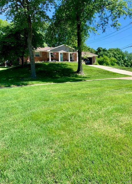 Located in sought after Parkway School District just minutes from the airport, downtown, shopping and entertainment this exquisite brick and vinyl sprawling ranch is one you wont want to miss.  Walk up to a professionally built verssalock wall surrounding a welcoming front covered front porch for morning coffee or evening sunset.  Enter to wood floors, electric fireplace (negotiable), and large open eat in kitchen.  Updated with stainless steel appliances and double pane windows in 2017 this kitchen has a large pantry, pull out storage shelves, gas range, deep under mount trough sink and quartz counter tops. Updated interior doors.  Nice sized Master Bedroom suite with 2 additional BR’s and hall bath.  Lower level is finished w/dry bar, projector TV, 2 possible sleeping rooms, office/craft room and 3rd bath plus storage/laundry area.  Oversized 2 car garage will hold bass boat.  Back yard has covered patio with TV, play equipment & fenced.  Stop by for a look this is your next home.