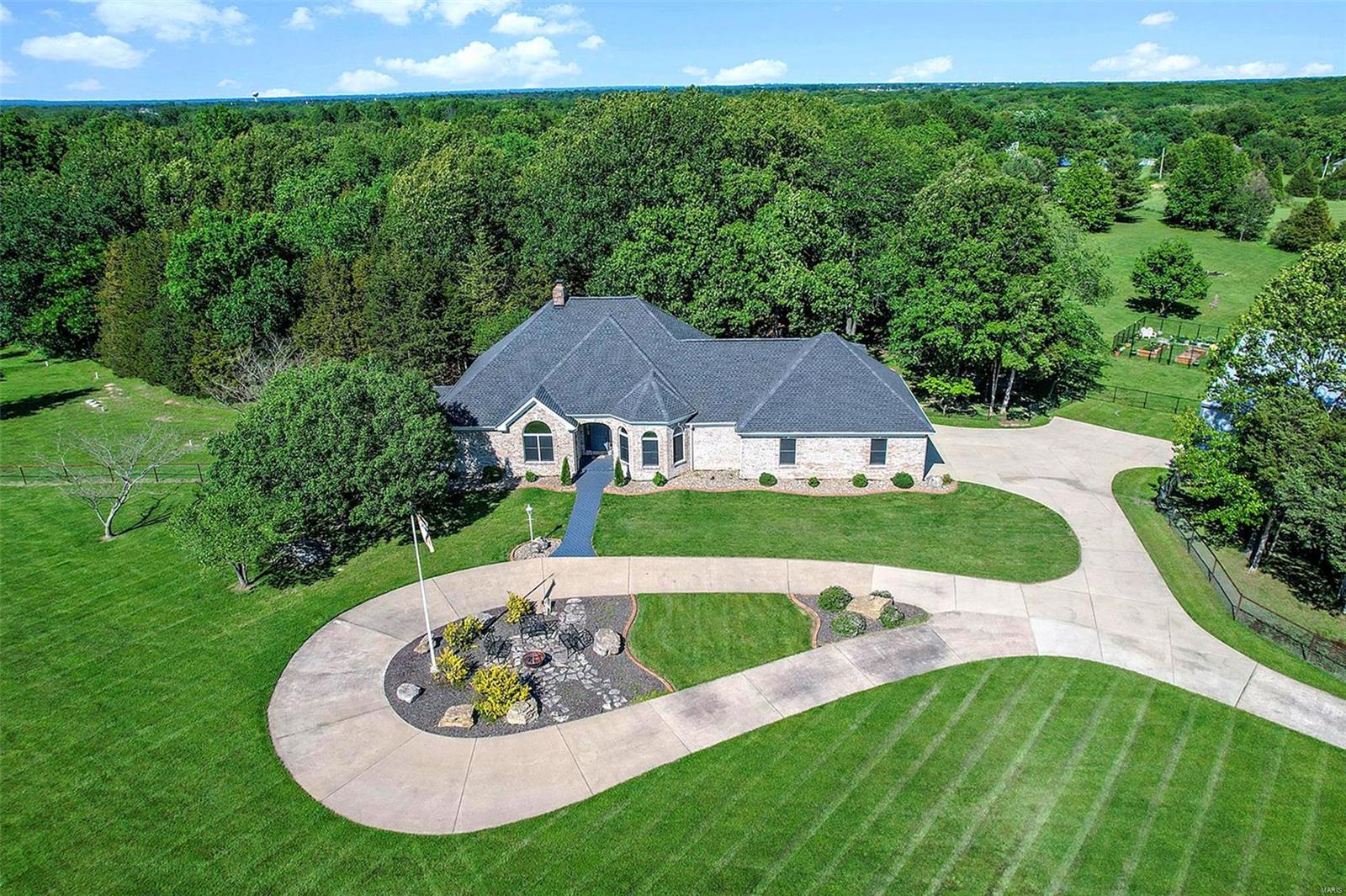 Attention pilots and airplane enthusiasts! Don’t miss out on this gorgeous 10-acre property that provides tranquility from the daily hustle and bustle yet is close to amenities, cultural events around St. Louis and the international airport.

This private community features a ½ mile grass airstrip that is shared amongst the community owners and allows for take offs and landings from your front step.

The home boasts 4 bedrooms, 4 bathrooms, finished lower level, walk out covered patio. A 60 x 60 insulated hangar, 40' bifold door with electric/ water plus a small garage for your garden tools. Recent added farm fence allows for horses or other livestock.

A beautiful large deck with gazebo overlooks the backyard pasture. The porch was recently updated with glass windows.

The great room features floor to ceiling windows with views of the yard & airstrip. The open and inviting kitchen with huge walk-in pantry is a chef’s dream. A fitness room is in the basement (equipment stays). Additional Rooms: Mud Room