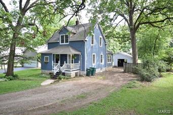 Idyllic setting and so inviting!  You'll feel as though you have stepped back in time in this lovingly updated century farm house on .4 acre lot!  So many special features here - from the front porch to the nice 304' deep lot, this is the perfect home for your wicker and lace and those beautiful antique pieces!!! Main floor master suite, nice neutral décor, sun-lit rooms, beautiful wood floors, open shelving in eat-in kitchen and 2 beautiful newer bathrooms!  Ah yes.... and did I mention main floor laundry room, too, and covered patio by garage, perfect for entertaining - it just doesn't get any better than this in the heart of Webster Groves!