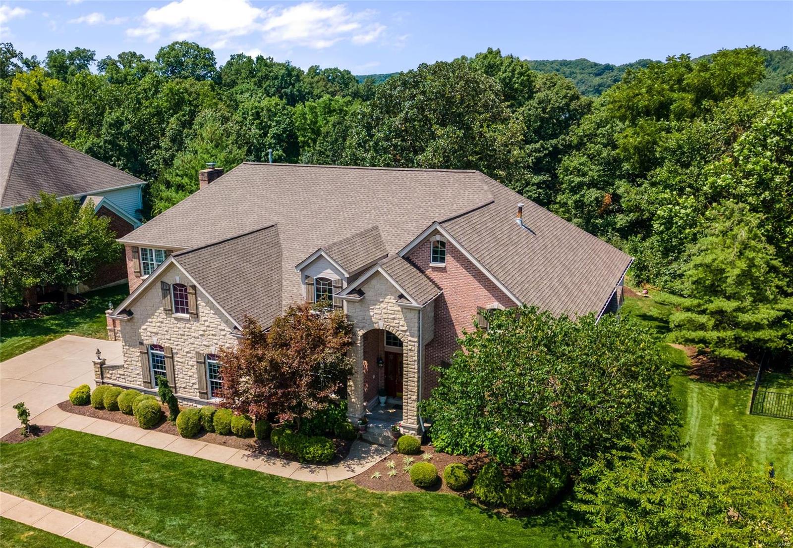 Impressive 5 bedroom, 1.5 story home in the Wings of Eagle Crest! Over 7000 finished sq ft of luxury space on a one acre lot backing to trees. Two-story entry foyer with elegant marble flooring is flanked by the study with French doors & built-ins and the formal dining room featuring a tray ceiling. The great room boasts an 18-ft ceiling, Palladian windows and double-sided gas fireplace. The kitchen has been recently updated with quartz counters, subway tile backsplash, new lighting, fresh paint and more. Main floor master suite offers 12-ft ceiling, bay window and sitting room with a fireplace. The upper level features three spacious bedrooms and a bonus room. A fantastic finished lower level awaits with rec room, exercise room, extraordinary wine cellar/wet bar, stone flooring, double-sided stone fireplace and fifth bedroom with a spacious full bath that would be great as in-law or teen suite. Composite deck overlooks the wooded yard boasting an award winning waterfall & pond.