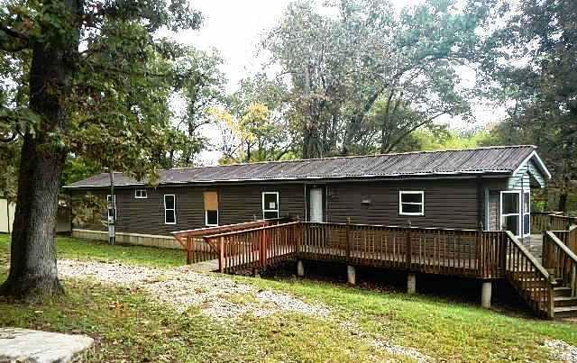 Spacious single wide mobile home with wrap around deck located on acreage with a separate pole barn! Located on over four acres, includes shed, lean-to and pole barn that has bathroom facilities started. There are three bedrooms, two baths and an open kitchen and living room. Easy to show! Property is on public water and a septic system. Set your appointment today! SpecialListingConditions: Foreclosure