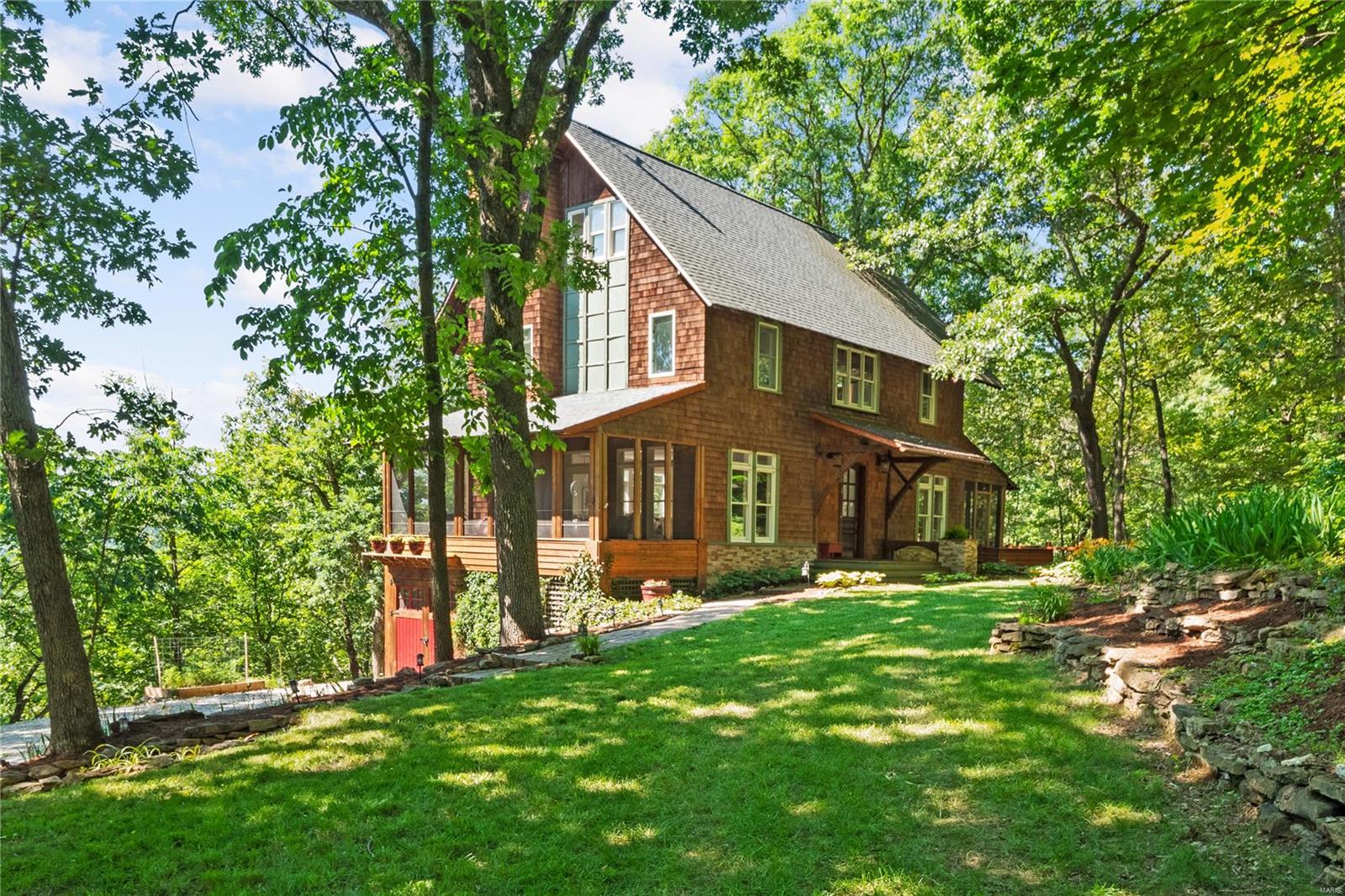 Welcome to your mountain chalet just minutes from downtown St Louis.  Local architect found the perfect spot to build his dream home - 2.5 wooded acres nestled on a hillside overlooking farmland where the Big river meets the Meramec. This delightful 4 bed/4 bath house sits 220 ft above the valley floor with 4 levels of living providing remarkable vistas from every floor. The impressive front door opens to expansive wood floors and walls of windows. The cozy gathering room with fireplace is open to the dining room & updated eat-in kitchen which features an 8’ island. Main level is flanked by two generous screened-in porches. Porch off kitchen is retro-fitted for year round grilling & walks out to deck that overlooks Koi pond & fire pit, perfect for entertaining. Master suite with fireplace. 40’ steel cable suspension bridge leads to charming treehouse. Fresh paint throughout, new roof 2015, Well 2018 & all new HVAC 2018. Well has cleared inspection. Close to shopping & Hwys.