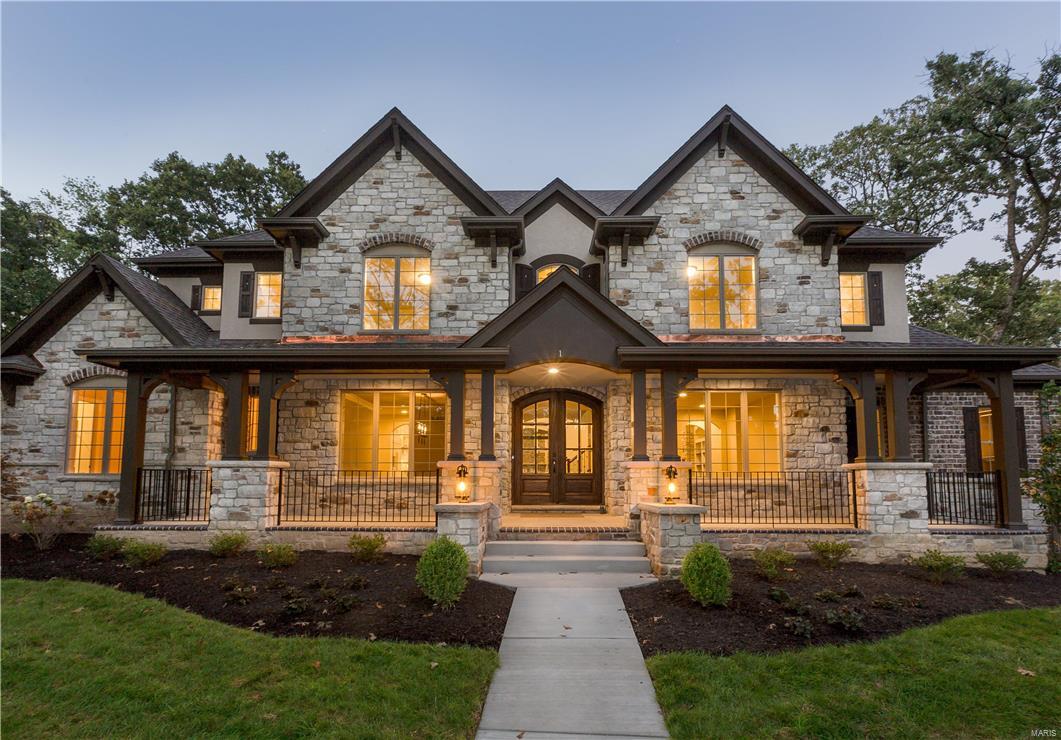 Another Flower Signature Custom 1.5 Story Design in a prime Frontenac location. Nestled on a wooded acre pool-friendly site, this stately stone/ stucco home with circle drive and full front porch offers 6 bedrooms, 7 baths, finished walk-out lower level with family room, wet bar, bedroom and bath. Upon entering the foyer flanked by a private study and a gracious dining room you will move into the vaulted and beamed "Gathering Room" which includes a gourmet kitchen w/ built-in refrigerator and Wolf Range, breakfast room and family room with stone fireplace flanked by bookcases, then into the sunny Garden Room. In addition to the luxurious master bedroom suite there is also a first floor guest suite. The second floor has 3 bedrooms with en suites and a loft area with overlook balcony. Hardwood floors, custom cabinetry, 8 foot solid doors, 3 zoned HVAC, 4 car rear entry garage, granite tops, built-in cubbies, central vac, security system and professional landscaping. Additional Rooms: Mud Room