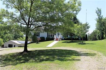 Pristine 3 bedroom ranch amongst a magnificent 21 acre setting and an additional 1500+ sq. foot building with endless possibilities*The car enthusiast, the boater, the collector, workshop, potential barn-electric and 2 oversized doors at both ends*Roll down the scenic lane to view this lovely home with great curb appeal*Enter find an open Great Room with wood floor, wood burning fireplace flowing to Dining Room with wood floor*Yummy kitchen has tons of cabinets, wood floor, granite, nice GE appliances, newer stainless refrigerator, slider door to large composite deck*Split bedroom design with Master suite offering walk in closet & luxury bath w/ceramic tile floor, soaking tub, sep. shower*Additional BRs 2/3 with full bath*Main floor laundry/mud rm, crown molding thru out main floor, boiler added for enhanced heat source, solar panels on house & out building, neutral décor*Mostly fenced property w/a combination of flat grassy area & woods*Truly a special home that should not be missed! Additional Rooms: Mud Room