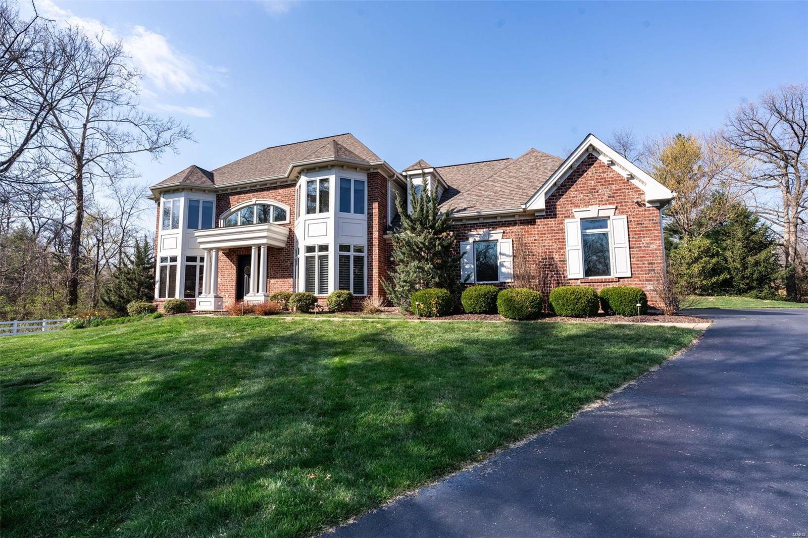 Located in a prestigious enclave, this 1.5-story house stands out on a peaceful cul-de-sac. This almost 1 acre lot offers plenty of room for expansion well beyond the pool fencing.  Step into the grand 20-foot foyer and be greeted by the recently updated staircase and more, including polished floors and a remodeled kitchen designed for efficiency and elegance. The home's custom details is enhanced by unique tray and box-beam ceilings and a  brazilan cherry-wood office. The living area flows into a temperature-controlled solarium with updated floors, showcasing views of the refreshed pool and deck. The kitchen features high Sub-Zero and Wolf appliances, blending effortlessly with a spacious hearth room  complete with a gas fireplace. The first-floor suite exudes luxury with private walkout to your pool, while the second floor presents three bedrooms, each with an en-suite baths, abundant natural light, and walk-in closets. Additional Rooms: Sun Room