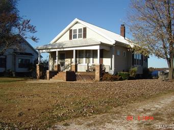 2 BDR W/POSSIBLE 3RD UPSTAIRS (24X11). Old fashion charm is what this home has. Original stained glass windows, 10ft ceilings, solid wood trim. Heat with electric or use the wood stove.  Full walkout basement, separate dinning with a dry bar, main floor laundry, and an old smoke house out back with a beautiful view. Oh, and we can't forget the 1 year old metal roof. Make this house your home.