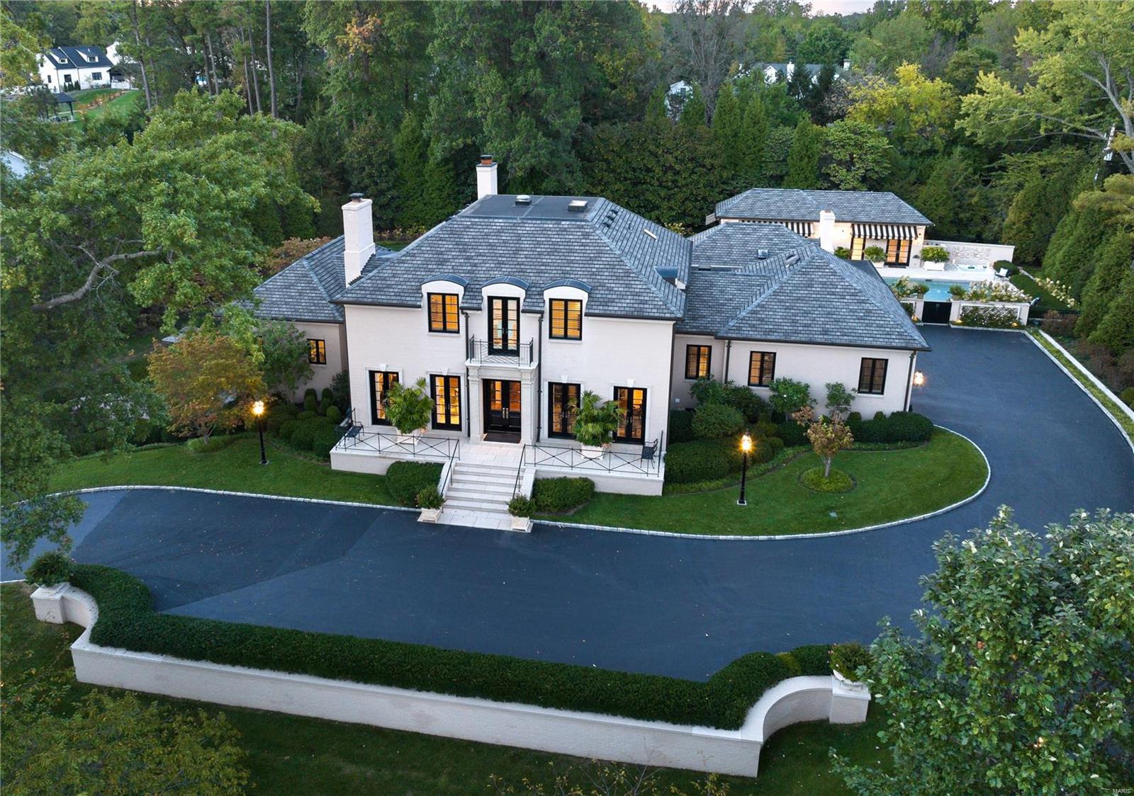 Resplendent, singular worldwide and breathtaking in every conceivable way. This magnificent property is detailed inside and out in  highest level of finishes, with no amenity overlooked. Hallmarks include Venetian plaster walls, tray, box and barrel ceilings, LED lighting and full home automation. Over 7,200SF living space in the Main House on 3 levels + 4 season fully independent pool house. Multiple sets of French doors open to a covered terrace, screened lanai, outdoor kitchen, fireplace, and inspirational heated pool with fountains and spa. Expansive Main Level Primary Suite, dual organized closets and world-class bath. 3 full Suites on 2nd level, one with Juliet balcony. Kitchen outfitted in premium appliances and quartz counters, opens to Hearth Room. Lower Level provides 5th bedroom/office Suite; Rec/media room, fitness center and 2 baths. Geothermal heating and cooling. 4 total laundry areas. 3-car heated garage. Professionally landscaped/hardscaped. Please see video link.