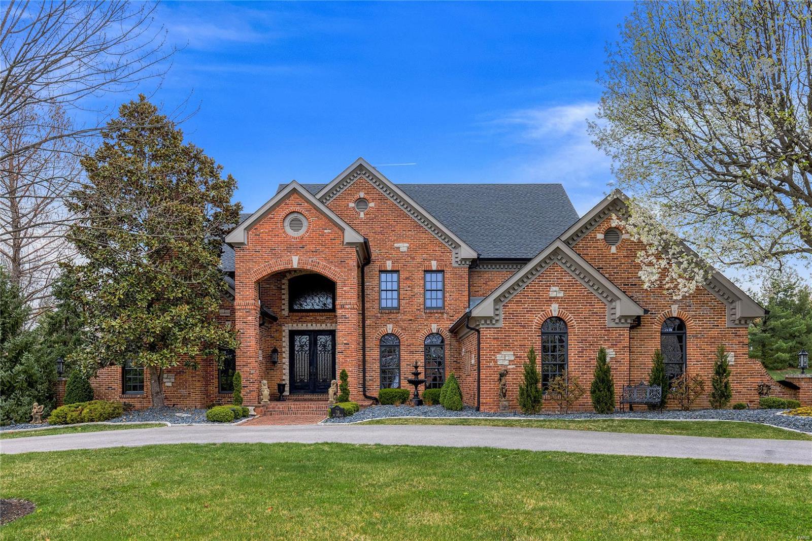 Spectacular 1.5-sty estate home from award winning builder, DeShetler Homes! Prominently situated on a gated lane, this custom-built home with its circular drive & impeccable landscaping makes a stunning entrance. Grand 2-sty foyer with curved staircase leads to library-paneled study, elegant dining room & 2-sty great room with stone fireplace & wall of windows. Exceptionally large kitchen with 42” custom cabinetry, granite countertops, Wolf appliances, & center island adjoins light-filled breakfast room & vaulted hearth room highlighted by floor-to-ceiling stone fireplace flanked by built in bookcases. Main floor primary bedroom suite features outstanding walk¬-in closet & lavish bath with shower spa & soaking tub. Front & rear staircases access 4 additional bedrooms, 2 with ensuite baths & 2 with Jack n’ Jill bath. Incredible Lower Level includes recreation room with fireplace, game room, wet bar & half bath. Premium 1-ac lot with resort style pool surrounded by landscaped gardens. Additional Rooms: Mud Room